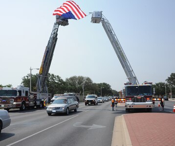 Both the Schertz and Universal City Fire Departments paid their respects to Army Sgt. Thomas A. Bohall of Bel Aire, Kan., by draping the American flag outside the main gate of Randolph Air Force Base, Texas, when the processional transporting the remains of Sergeant Bohall, made its way out the base headed to a San Antonio funeral home June 7. Sergeant Bohall was assigned to the 4th Battalion, 101st Aviation Regiment, 159th Combat Aviation Brigade, 101st Airborne Division (Air Assault), Fort Campbell, Ky. Sergeant Bohall was one of six soldiers from Fort Campbell who were supporting Operation Enduring Freedom and killed by an improvised explosive device during an insurgent attack May 26, 2011 in Kandahar province, Afghanistan. (U.S. Air Force photo/Rich McFadden) (released)