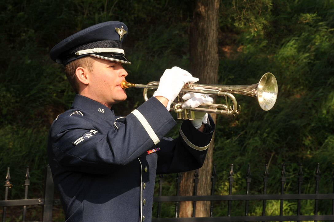 OFFUTT AIR FORCE BASE, Neb. - Airman 1st Class Timothy R. Schleinat of the Heartland of America Band plays taps at the annual Memorial Day service held at the Offutt Air Force Base cemetery May 30th. The Memorial Day service is held annually to honor veterans from all eras who have served our nation. Air Force Photo by D.P. Heard
