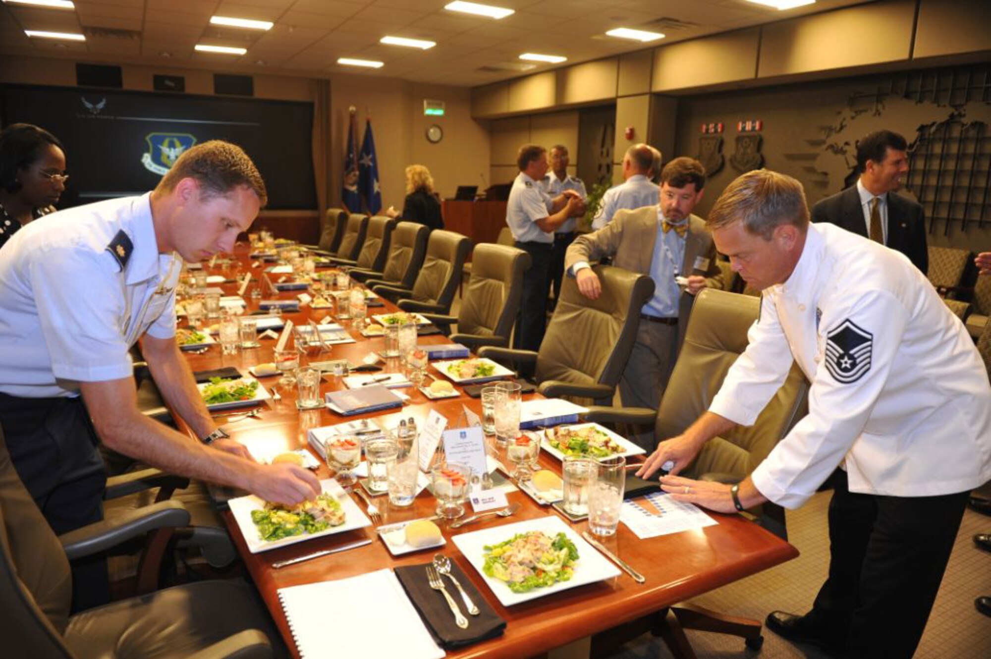 Maj. Ryan Rasmussen, left, chief of protocol at Headquarters Air Force Reserve Command, and Master Sgt. Mark Robinson, aide to the AFRC commander, prepare lunches for six local mayors who visited Headquarters AFRC at Robins Air Force Base, Ga., June 3, 2011. (U.S. Air Force photo/Gary Cutrell)