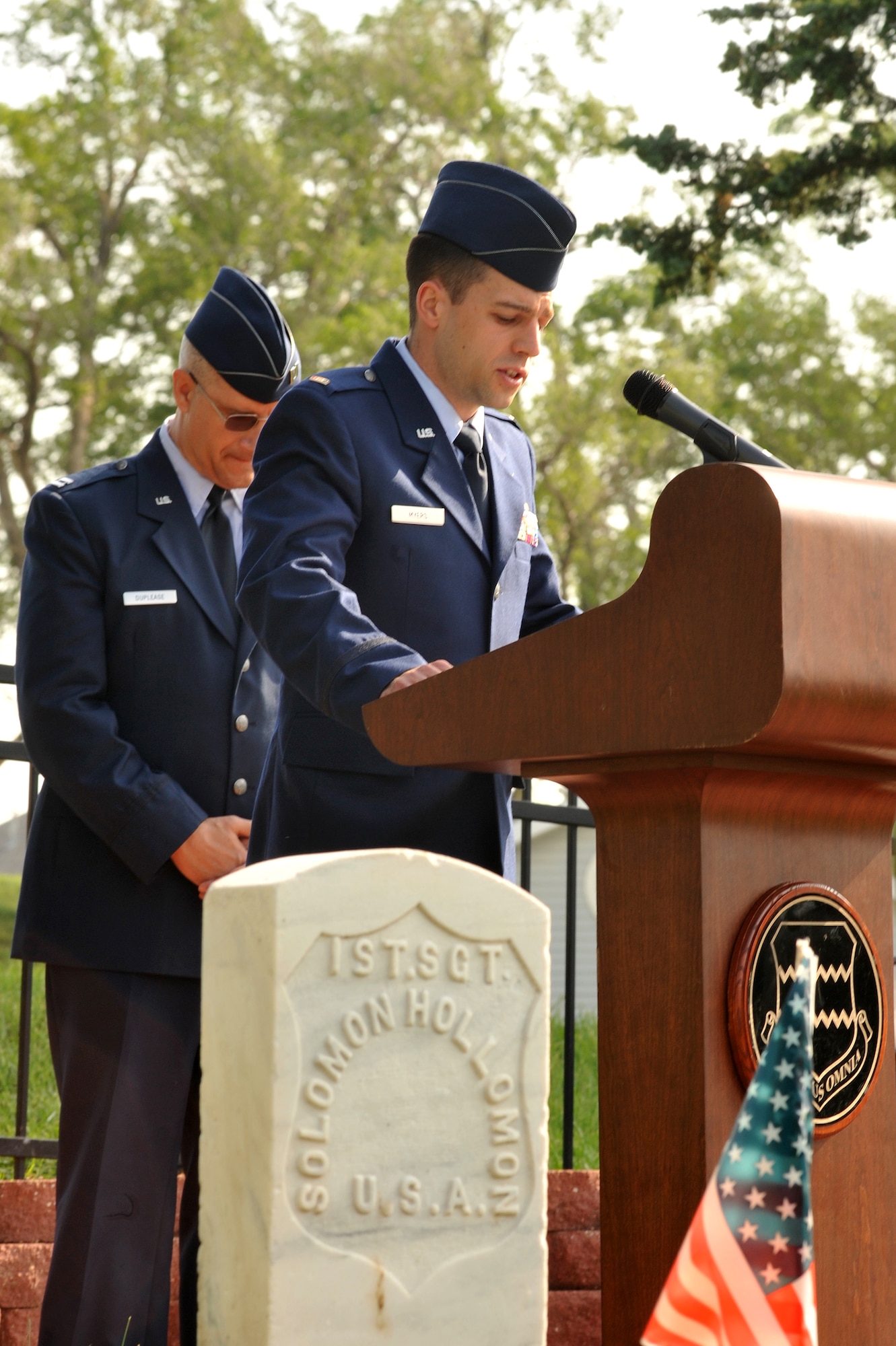 OFFUTT AIR FORCE BASE, Neb. - 2nd Lt. Jamie P. Myers leads a prayer for fallen heroes at the annual Memorial Day ceremony at Offutt Air Force Base May 30th. Capt. Robert Duplease, 55th Wing, behind him bows his head in prayer.  The Memorial Day service is held annually to honor veterans from all eras who have served our nation. U.S. Air Force Photo by D.P. Heard
