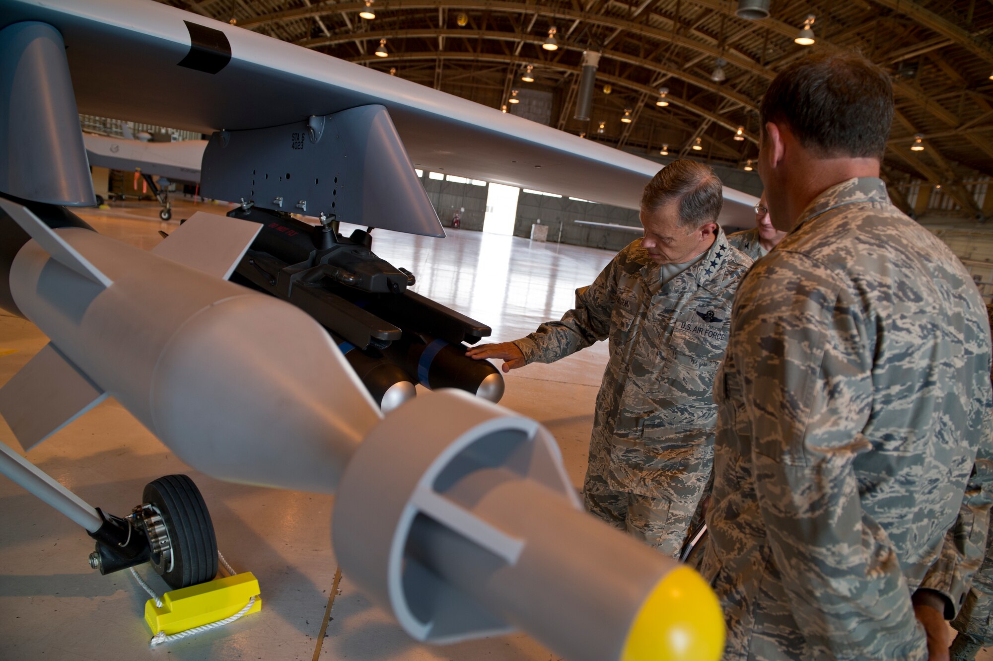 HOLLOMAN AIR FORCE BASE, N.M. -- Gen. William M. Fraser III, commander of Air Combat Command, analyzes a guidance missile on an MQ-9 Reaper, June 1, 2011, during his visit to the base. The 49th Wing explained the aircraft’s capabilities to General Fraser as well as the transition from contract maintenance to Air Force maintenance.  (U.S. Air Force photo by Airman 1st Class Joshua Turner/Released)