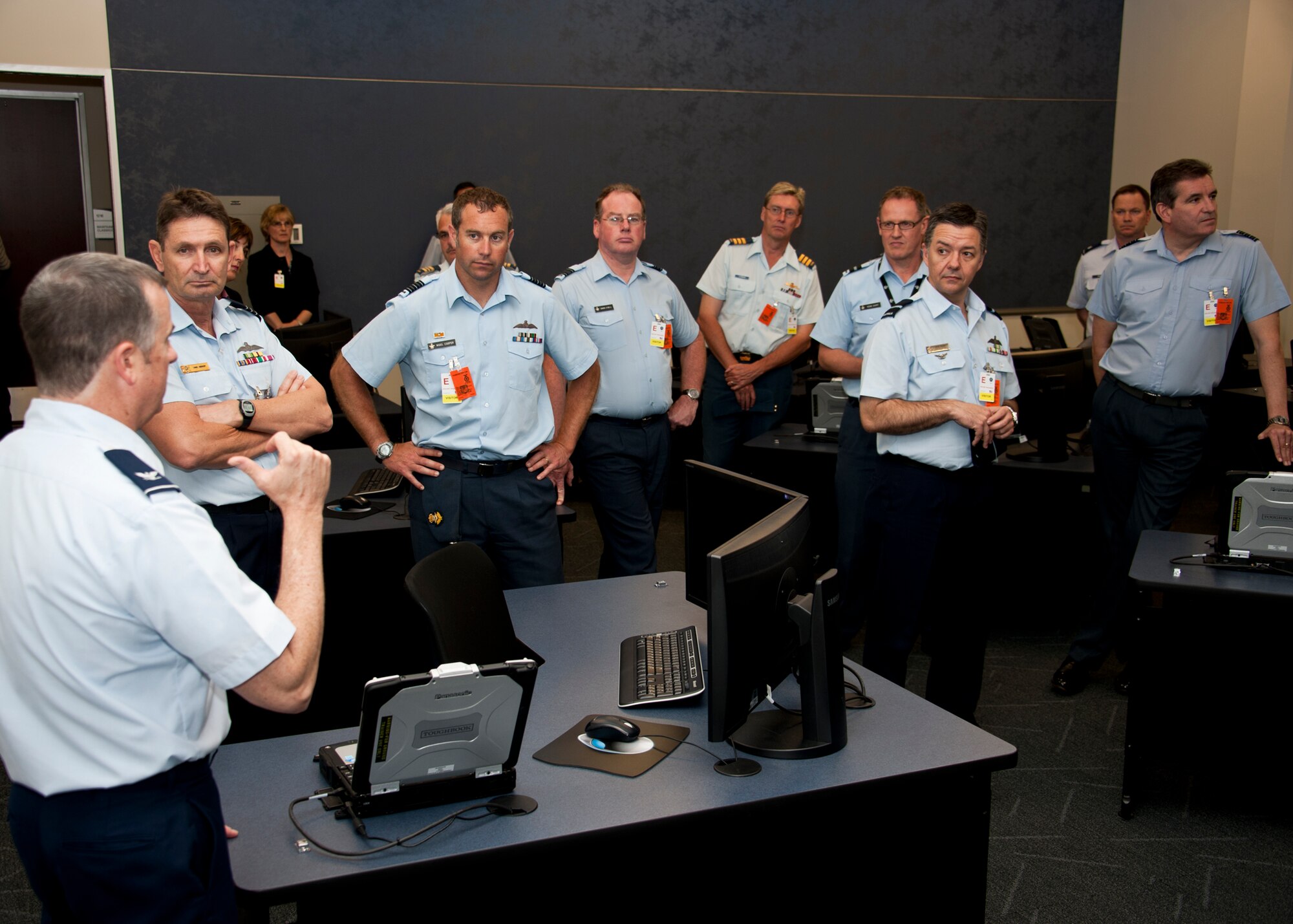 Col. Greg Jones, Joint Strike Fighter academic training center deputy director, briefs members of the Air Space Interoperability Council about the maintenance training classrooms during a tour of the Joint Strike Fighter academic training center June 6 at Eglin Air Force Base, Fla.  ASIC is an assembly of leaders from the air forces of Australia, Canada, New Zealand, the United Kingdom and the United States.  The objective of the group is to ensure member nations are able to integrate seamlessly in joint and combined operations.  Eglin played host to the ASIC members for their annual national directors meeting.  (U.S. Air Force photo/Samuel King Jr.)