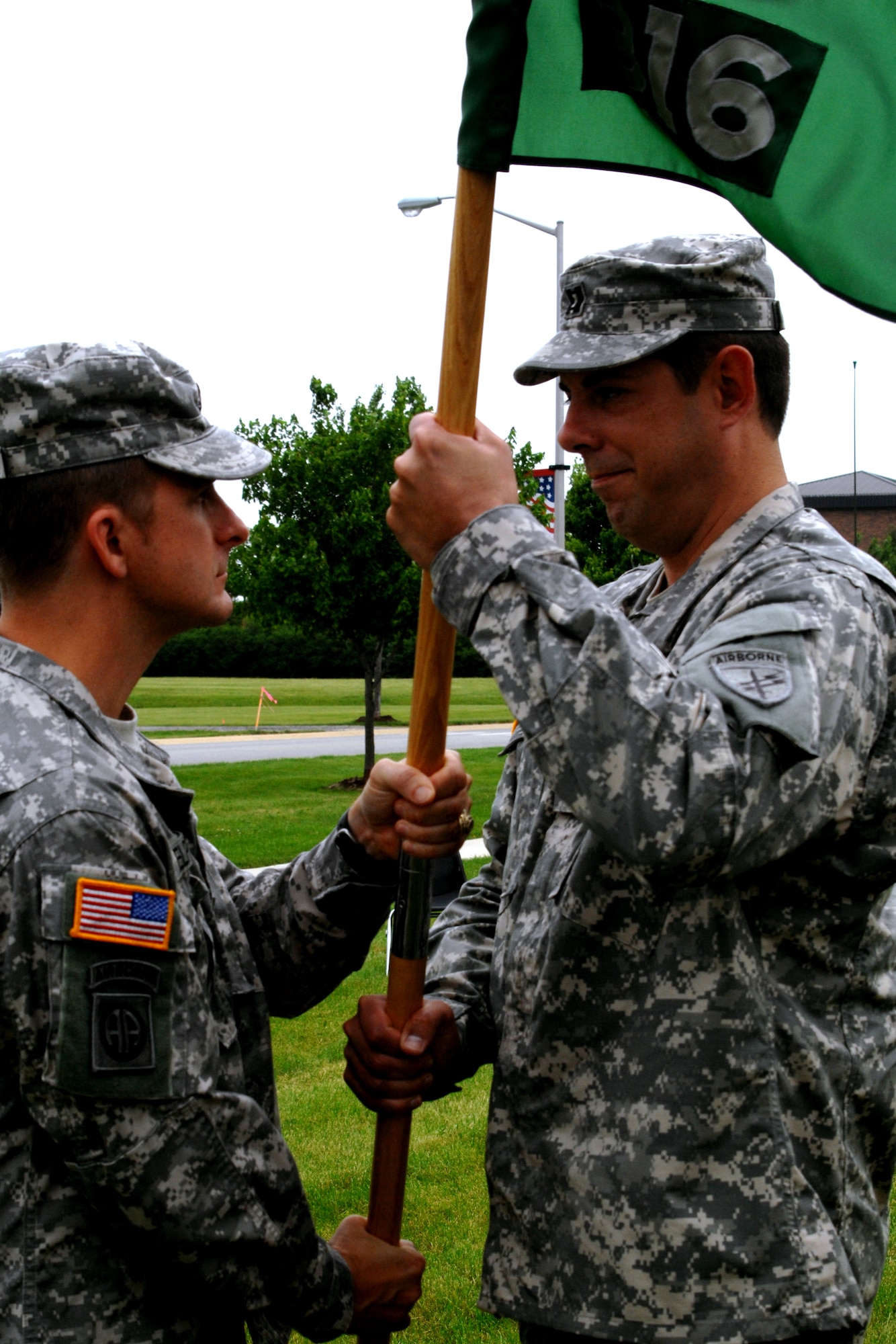 GRISSOM AIR RESERVE BASE, Ind., -- Capt. Gregory Baugh, left, receives the company flag as he takes command of the 316th Psychological Operations Company, here June 5. Captain Baugh received the flag from Lt. Col. Greg Elpers, 16th Psychological Operations Battalion, Fort Sheridan, Ill. (U.S. Air Force photo/Tech. Sgt. Doug Hays)
