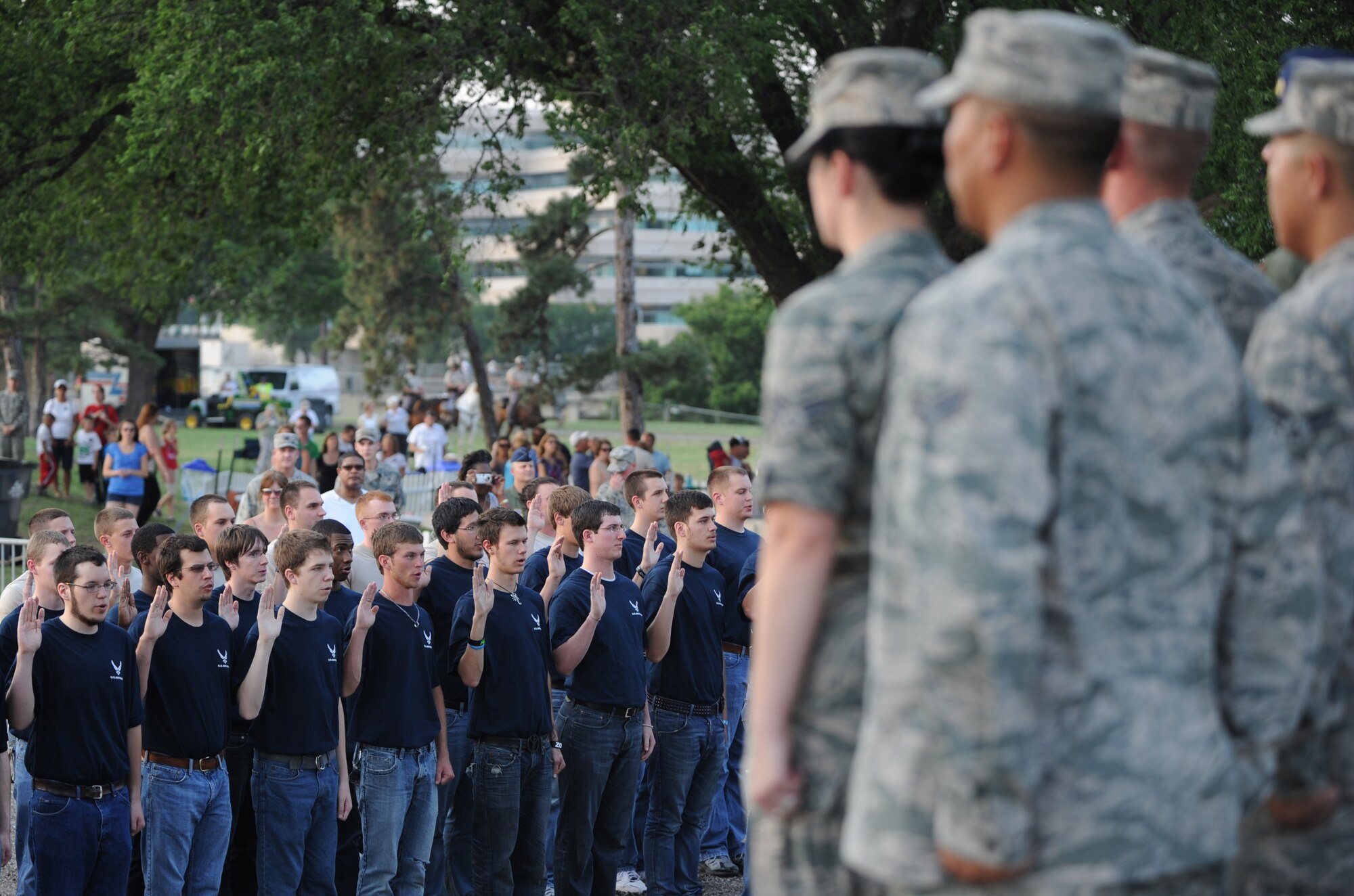 New recruits raise take the oath of enlistment given by Col. Jamie Crowhurst, 22nd Air Refueling Wing commander June 3, 2011, Wichita, Kan. Ninety recruits in the Air Force’s delayed enlistment program were sworn in at the 2011 Wichita River Festival. The annual festival, held this year June 3 through June 11, is used to build community pride and bring people together to focus on Wichita’s natural resource, the Arkansas River.  (U.S. Air Force Photo/Airman 1st Class Katrina M. Brisbin)