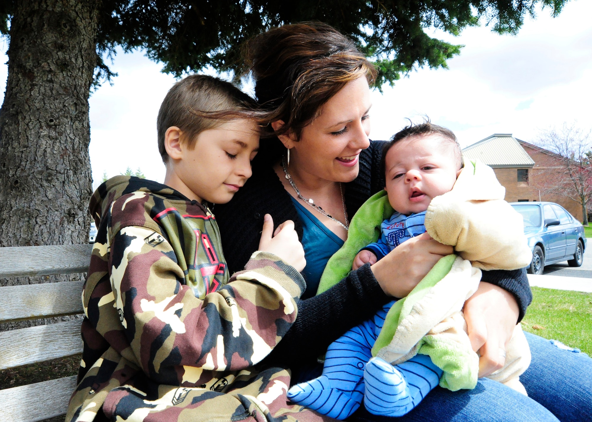 Jenevra Watkins, and her sons Quintus, 3 months old, and Antonio, 9, huddle together April 28, 2011, at the Airman Family and Readiness Center at Fairchild Air Force Base, Wash. The family was stationed in Japan and evacuated shortly after the earthquake in March. (U.S. Air Force photo/Airman 1st Class Taylor Curry)