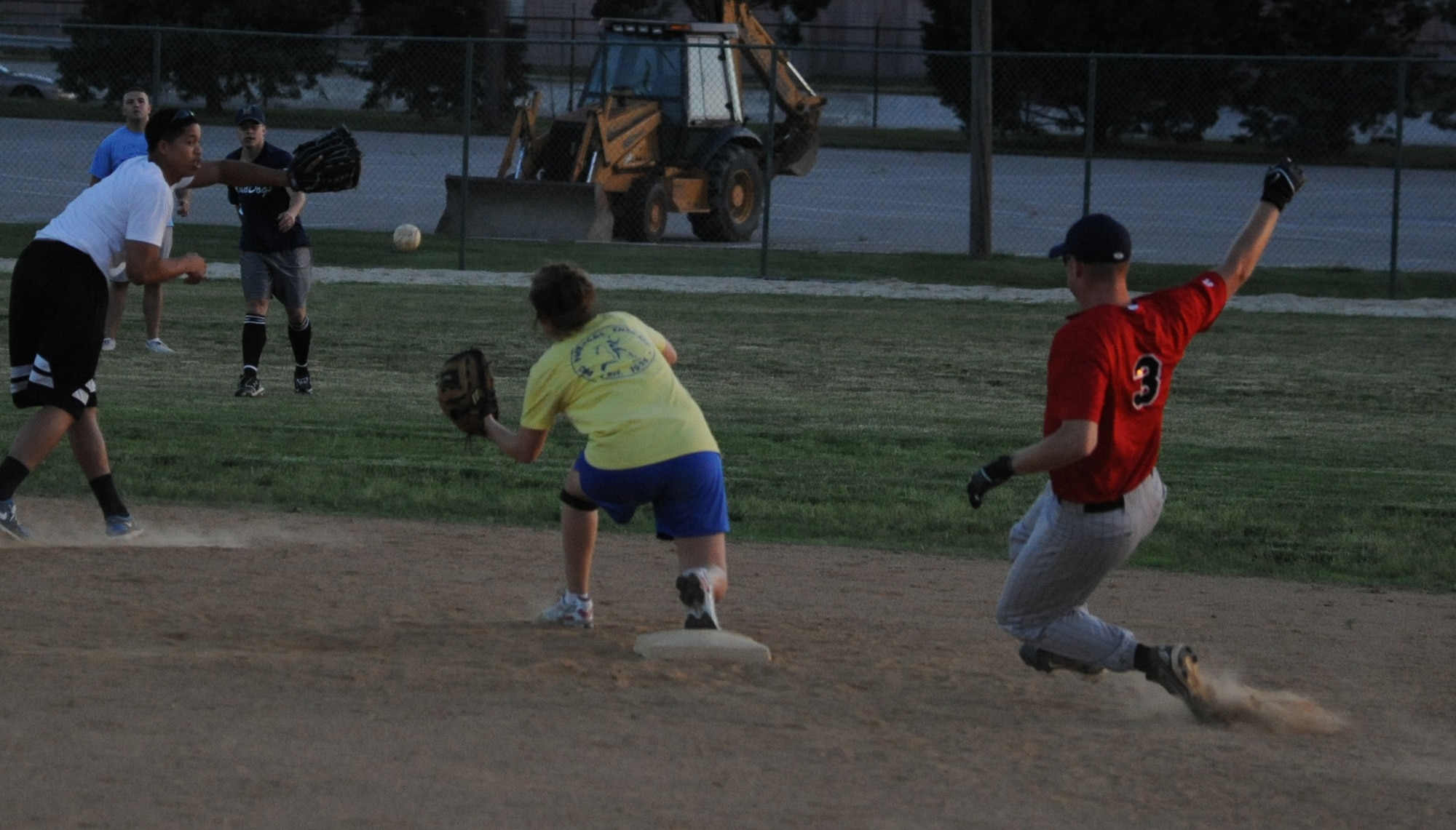 (Right) Chad Diehl, 436th Civil Engineer Squadron first baseman, races the ball to second base during an intramural softball game against the 436th Operations Support Squadron June 2, 2011 at Dover Air Force Base, Del.  436 CES defeated 436 OSS 11 – 0.  (U.S. Air Force photo by Staff Sgt. Chad Padgett)