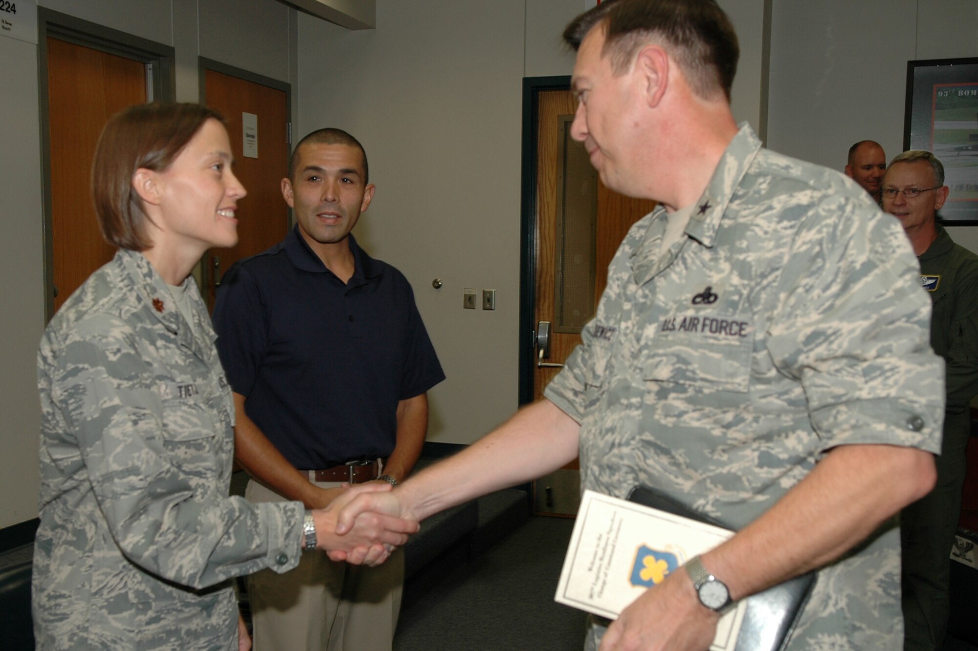 Gabe Tietje looks on as Brig. Gen. Gary Blaszkiewicz, the director of logistics for Air Force Reserve Command, congratulates his wife, Maj. Silke Tietje, the new commander of the 307th Logistics Readiness Squadron after a change of command ceremony at Barksdale Air Force Base, La., June 4, 2011. General Blaszkiewicz was at Barksdale for a familiarization visit to the 307th Bomb Wing and 917th Fighter Group and took time out of his schedule to attend the ceremony. (U.S Air Force photo by Senior Master Sgt. Jessica Daurizio)