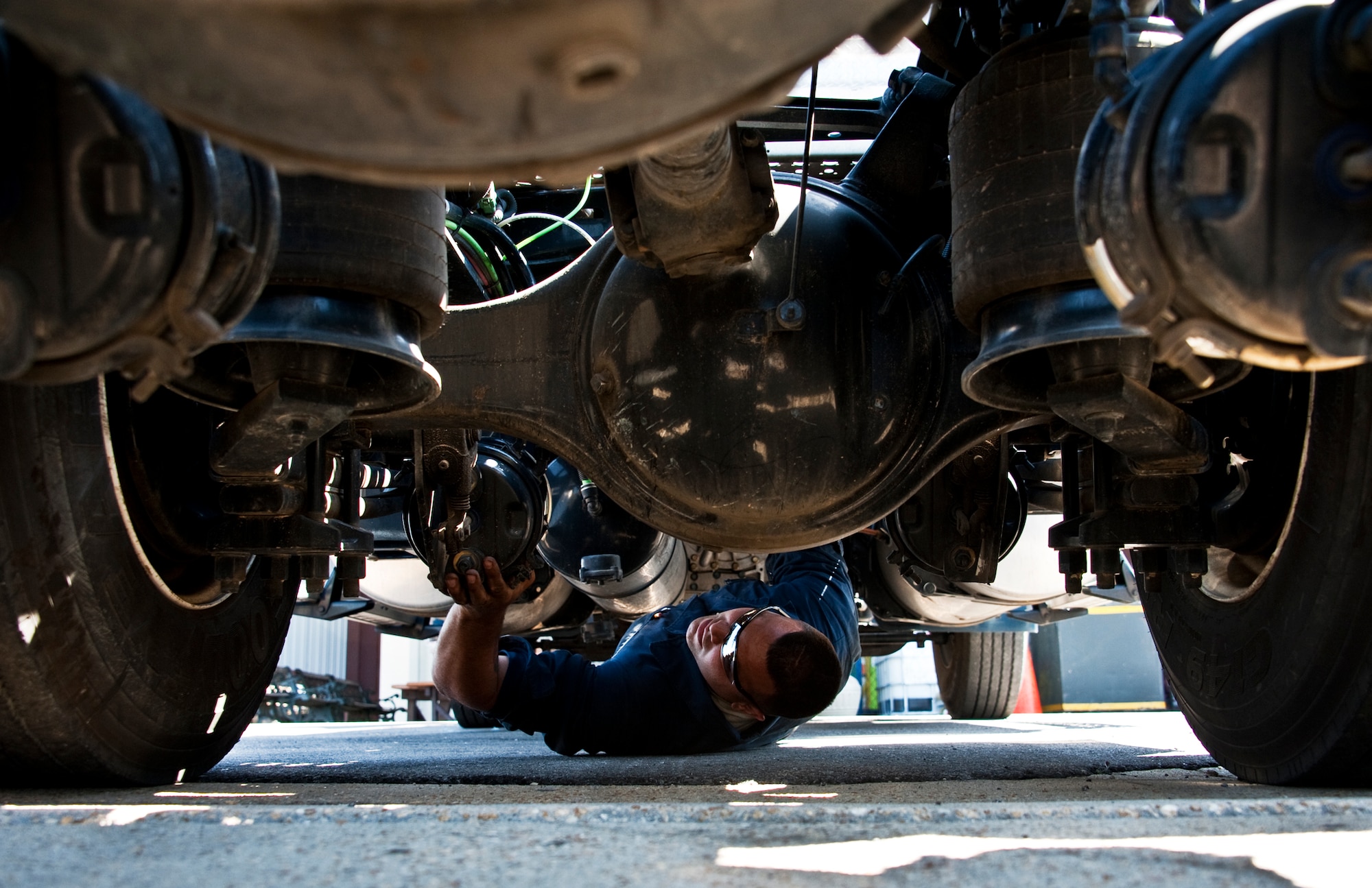 Staff Sgt. Russell Pinola, 96th Vehicle Management Flight, looks for leaks underneath a truck during an annual nuclear surety inspection of the vehicle.  Any vehicle that operates or moves weaponry is subject to a thorough serviceability inspection to ensure it meets all manufacturer specifications.  Nuclear sustainment is one of the top priorities of Air Force Materiel Command Commander, Gen. Donald Hoffman.   (U.S. Air Force photo/Samuel King Jr.)