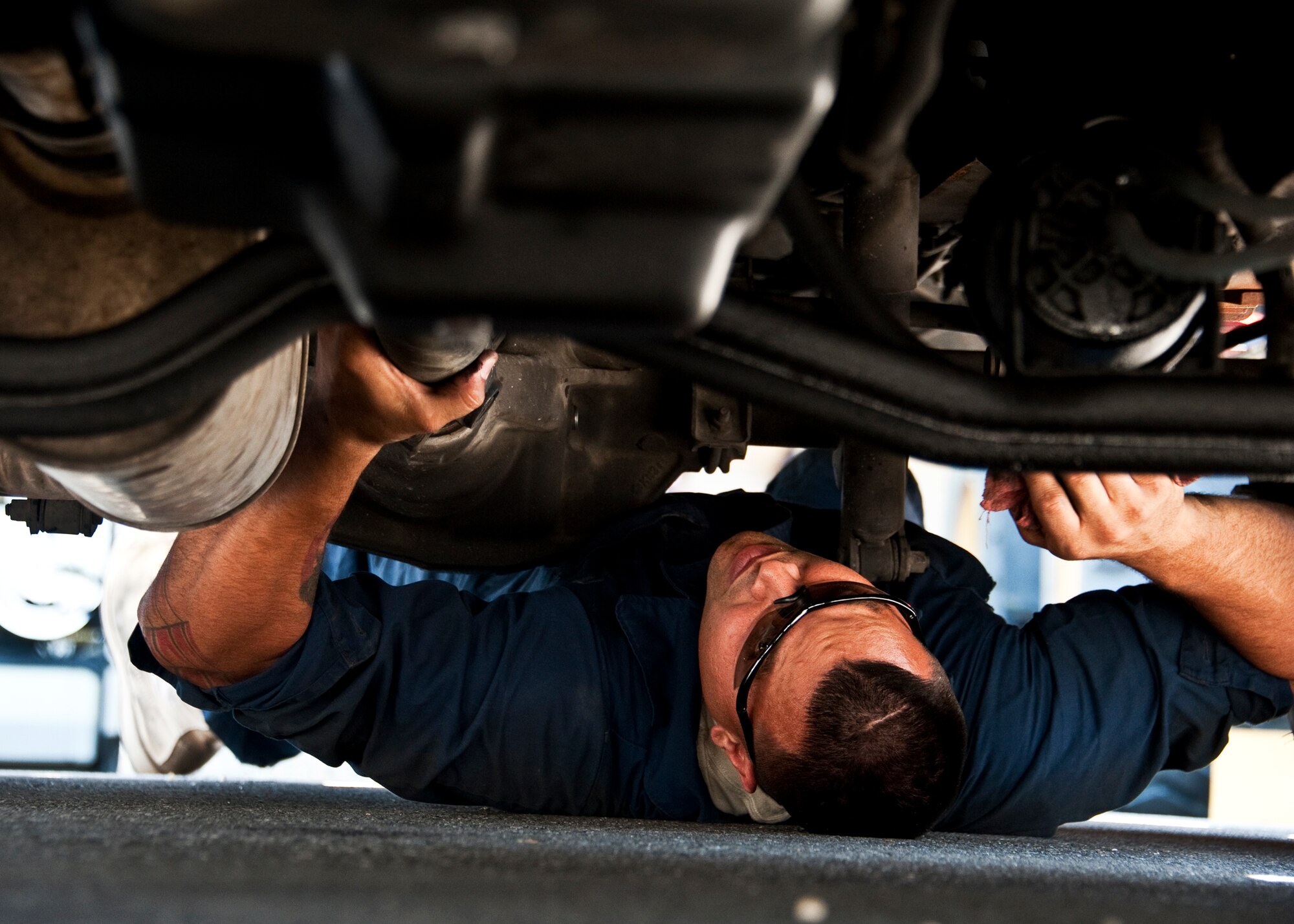 Staff Sgt. Russell Pinola, 96th Vehicle Management Flight, moves underneath a truck during an annual nuclear surety inspection of the vehicle.  Any vehicle that operates or moves weaponry is subject to a thorough serviceability inspection to ensure it meets all manufacturer specifications.  Nuclear sustainment is one of the top priorities of Air Force Materiel Command Commander, Gen. Donald Hoffman.   (U.S. Air Force photo/Samuel King Jr.)