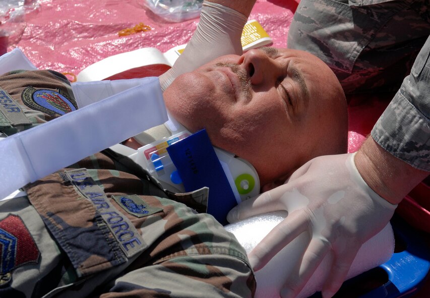Tech. Sgt. Tim Tesar, 56th Logistics Readiness Squadron noncommissioned officer in charge of safety, is strapped down to a stretcher to prevent further simulated injury during an active shooter exercise at Luke Air Force Base, Ariz., May 25, 2011. Tech. Sgt. Tesar suffered from a simulated gunshot wound to teh stomach. (U.S. Air Force Photo by Senior Airman Darlene Seltmann/Released)