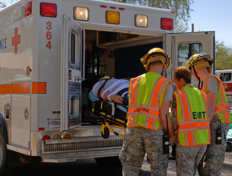 Members of the fire department and 56th Medical Group place simulated victims into an ambulance for transportation during an active shooter exercise at Luke Air Force Base, Ariz., May 25, 2011. (U.S. Air Force Photo by Senior Airman Darlene Seltmann/Released)