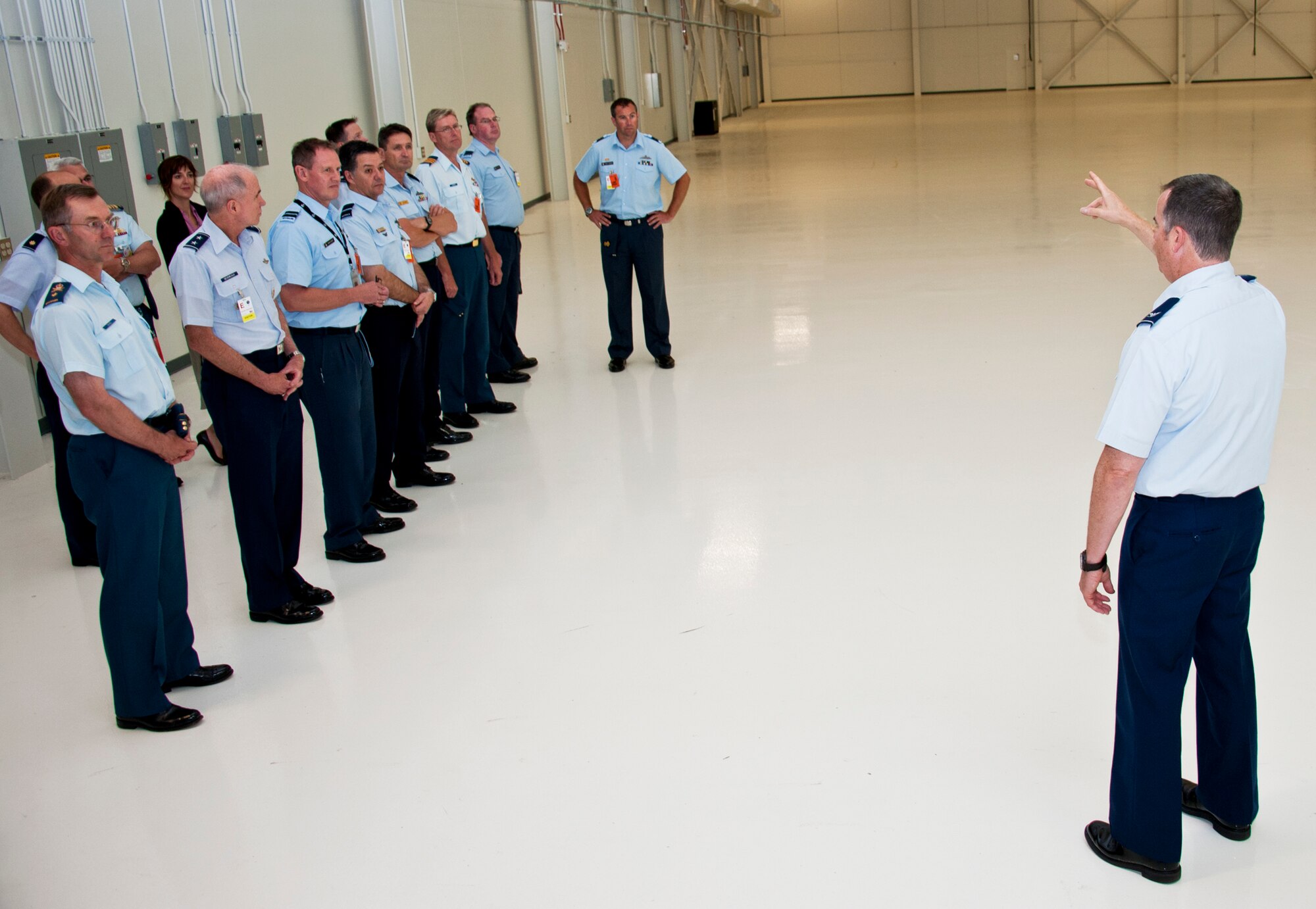 Col. Greg Jones, Joint Strike Fighter academic training center deputy director, briefs members of the Air Space Interoperability Council about one of the maintenance training bays during a tour of the Joint Strike Fighter academic training center June 6 at Eglin Air Force Base, Fla.  ASIC is an assembly of leaders from the air forces of Australia, Canada, New Zealand, the United Kingdom and the United States.  The objective of the group is to ensure member nations are able to integrate seamlessly in joint and combined operations.  Eglin played host to the ASIC members for their annual national directors meeting.  (U.S. Air Force photo/Samuel King Jr.)