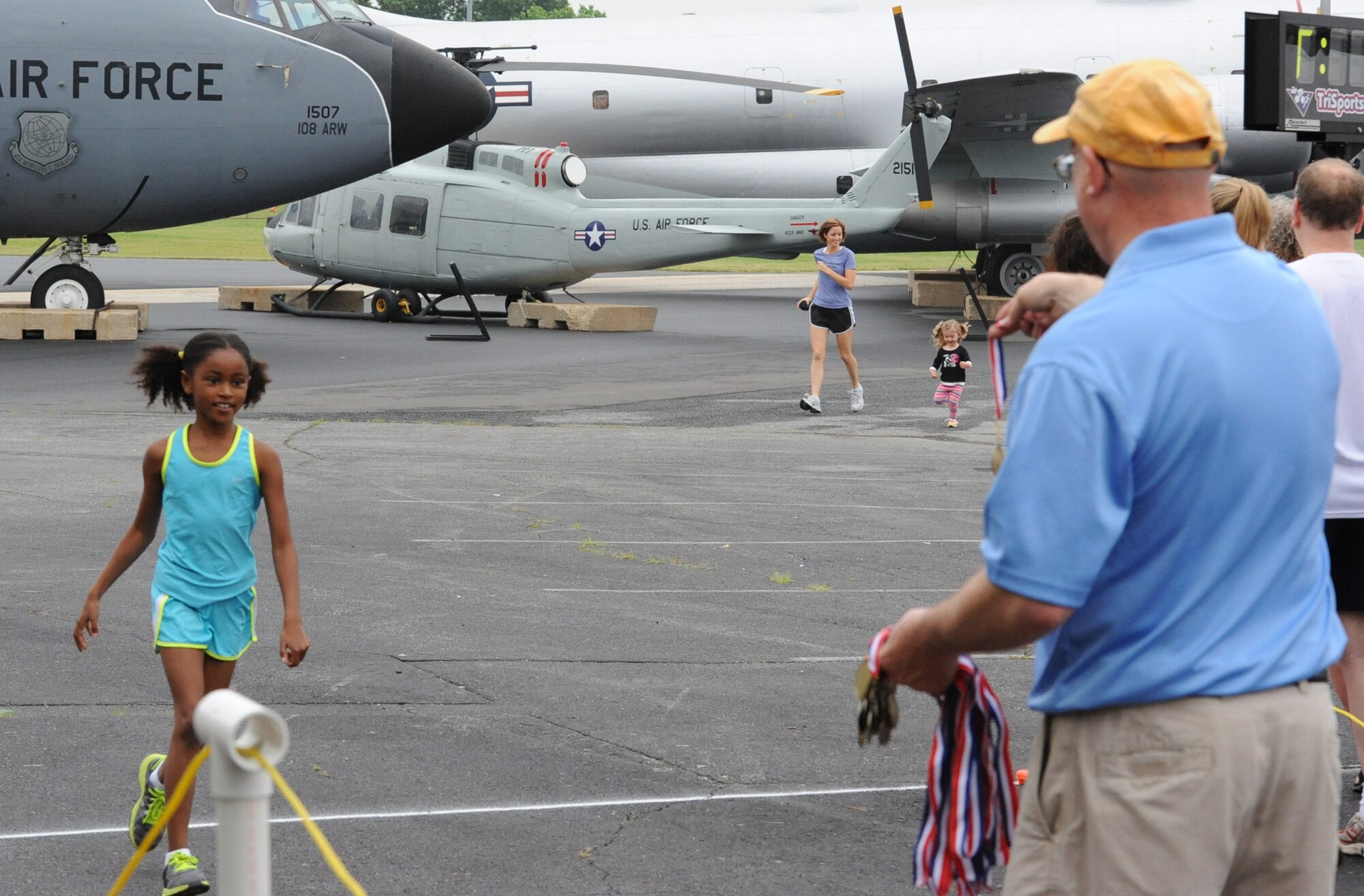 Simone Cathey, daughter of Lt. Col. Eric Cathey, 436th Dental Squadron commander, takes first place in the ‘Kiddie K’ 100 yard dash during the Heritage Half Marathon at the Air Mobility Command Museum June 5, 2011.  (U.S. Air Force photo by Staff Sgt. Chad Padgett)