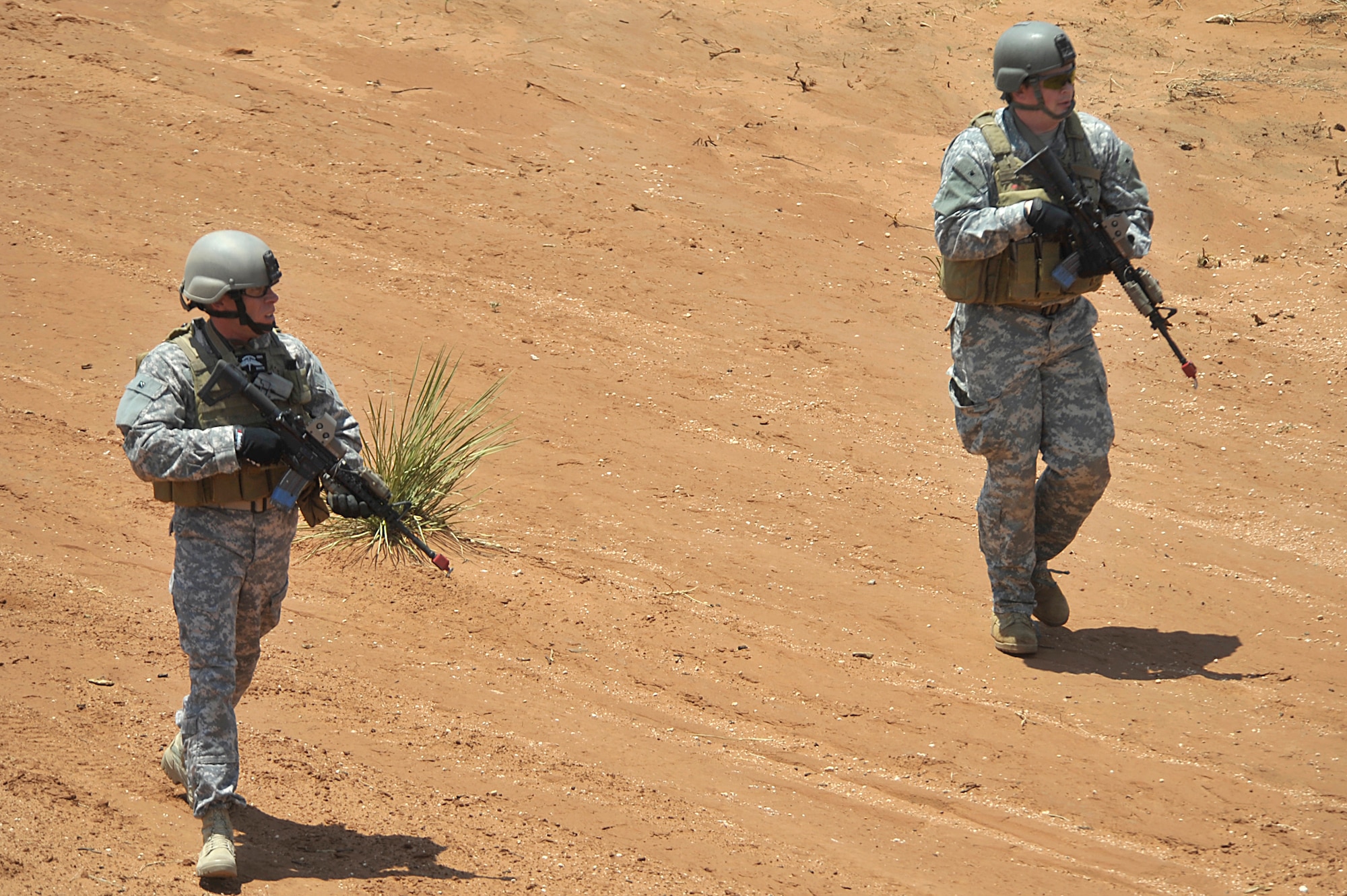 Personnel posing as friendly forces walk back to the safe zone after successfully simulating clearing a building as part of an aerial and ground demonstration for around 600 spectators at the 27th Special Operations Wing Capabilities Exercise, June 4, 2011, at Melrose Air Force Range. The CAPEX is an annual exhibition of the 27 SOW's many special operations aircraft and missions for Cannon Airmen and their families. (U.S. Air Force photo by Airman Ericka Engblom)(RELEASED)