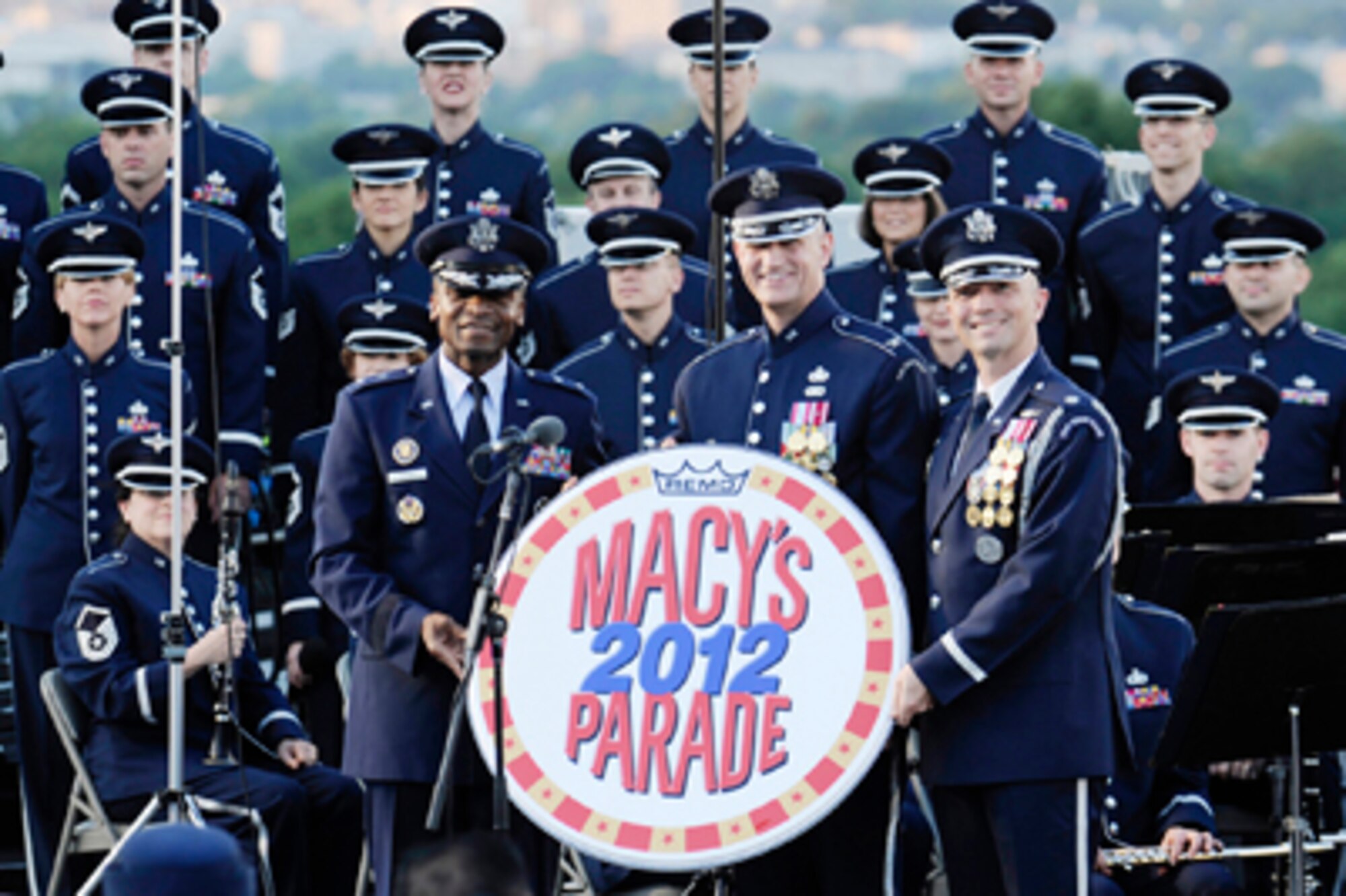 Maj. Gen. Darren W. McDew, Col. A. Phillip Waite and Lt. Col. Raymond Powell display the Macy's Day parade emblem June 4, 2011, at The Air Force Memorial in Arlington, Va., after receiving an invitation for the U.S. Air Force Band and U.S. Air Force Honor Guard to perform during the 2012 parade. General McDew is the Air Force District of Washington commander. Colonel Waite  is the USAF Band commander, and Colonel Powell is the USAF Honor Guard commander (U.S. Air Force photo/Staff Sgt. Raymond Mills)