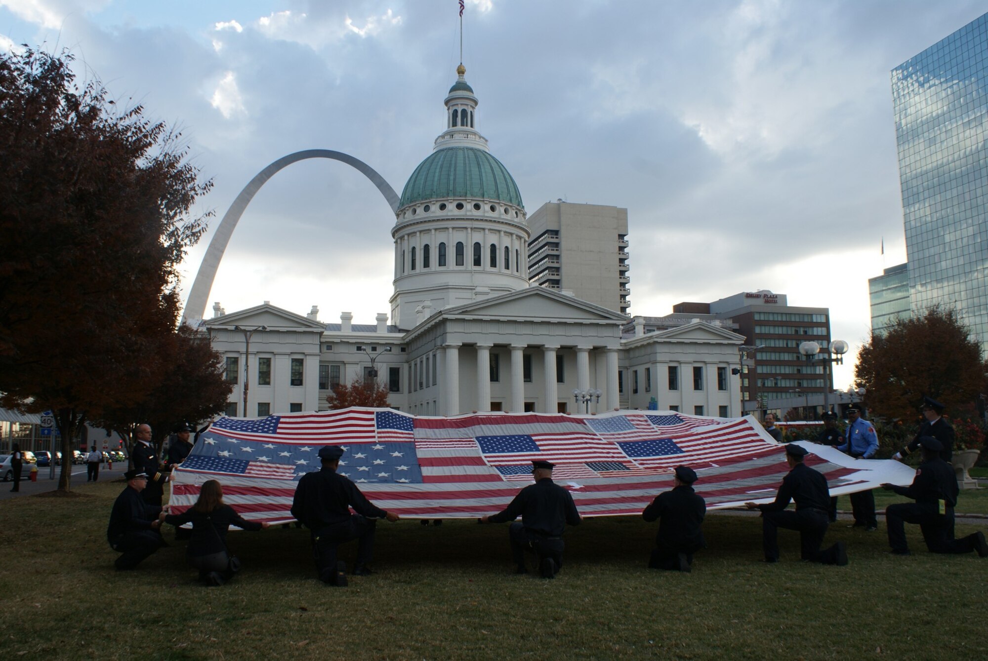 Members of several companies of local firefighters and first responders hold the National 9/11 Flag prior to a stitching ceremony on Veterans Day, November 11, 2010 in St. Louis, Mo. (Contributed Photo)