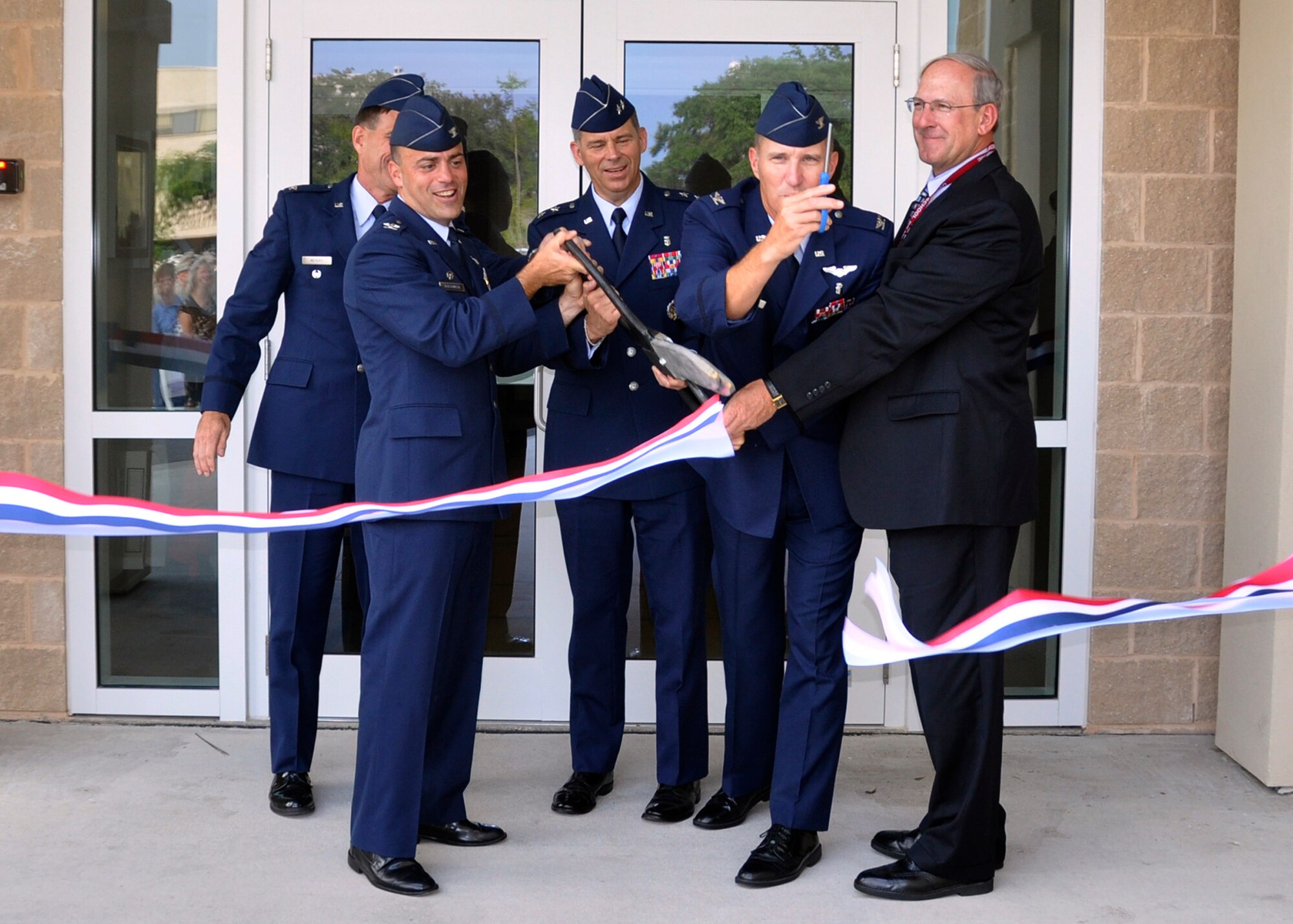From left, Col. Eric Meyers, 96th Dental Squadron commander; Col. Sal Nodjomian, 96th Air Base Wing commander; Maj. Gen. Gerard Caron, Air Force Assistant Surgeon General for Dental Services; Col. Gary Walker, 96th Medical Group commander and Tom Wisnieski, Director of Veterans Affairs, Gulf Coast Health Systems, cut the ribbon to open the Eglin Dental Clinic June 7.  (U.S. Air Force photo/Kevin Gaddie) 