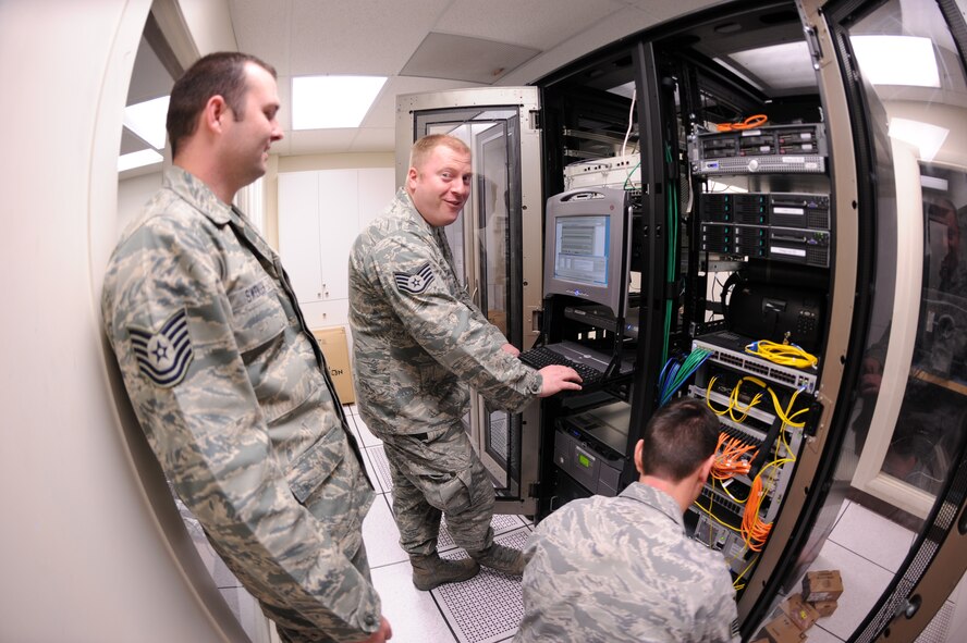Tech Sgt. Jason Swensen, Staff Sgt. Joe Allen and Staff Sgt. Harvey Williams finish configuring an Information Transfer Node (ITN) during a network upgrade to communications equipment at Gowen Field, Boise, Idaho on May 1st. Swensen, Allen and Williams are members of the 124th Communications Flight that worked to upgrade the base telecommunications network. (U.S. Air Force photo by Tech. Sgt. Heather Walsh)