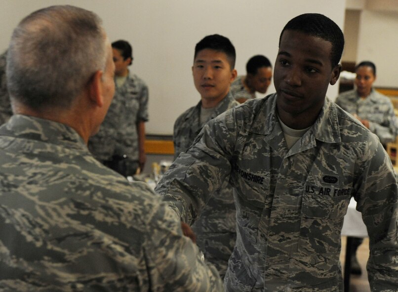 Lt. Gen. Jim Kowalski, Air Force Global Strike Command commander, meets Airman 1st Class Lawrence Devonshire of the 2nd Operations Support Squadron, at Barksdale Air Force Base, La., May 19. General Kowalski met with Barksdale Airmen at the Red River Dining Facility and answered their questions during breakfast. (U.S. Air Force photo/Airman 1st Class Micaiah Anthony)(RELEASED) 