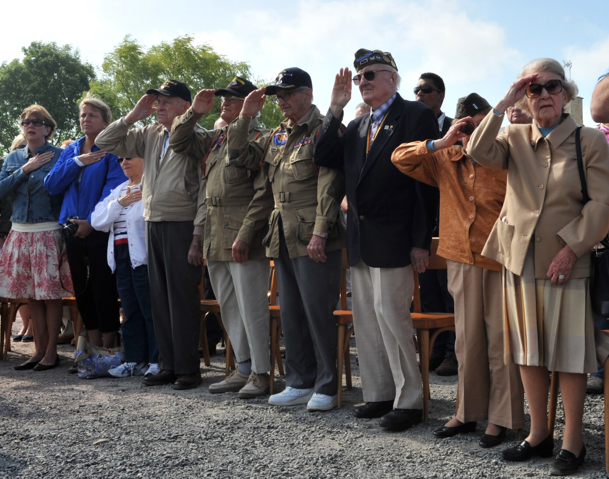 World War II veterans render a salute during the playing of national anthems at a ceremony in Picauville, France for the 67th Anniversary of D-Day, June 3, 2011. Each year since the liberation of Normandy, U.S. forces along with allied nations come together to honor those who gave the ultimate sacrifice on that day. This year's ceremony is scheduled to be attended by dozens of American World War II veterans. (U.S. Air Force photo by Senior Airman Caleb Pierce) 