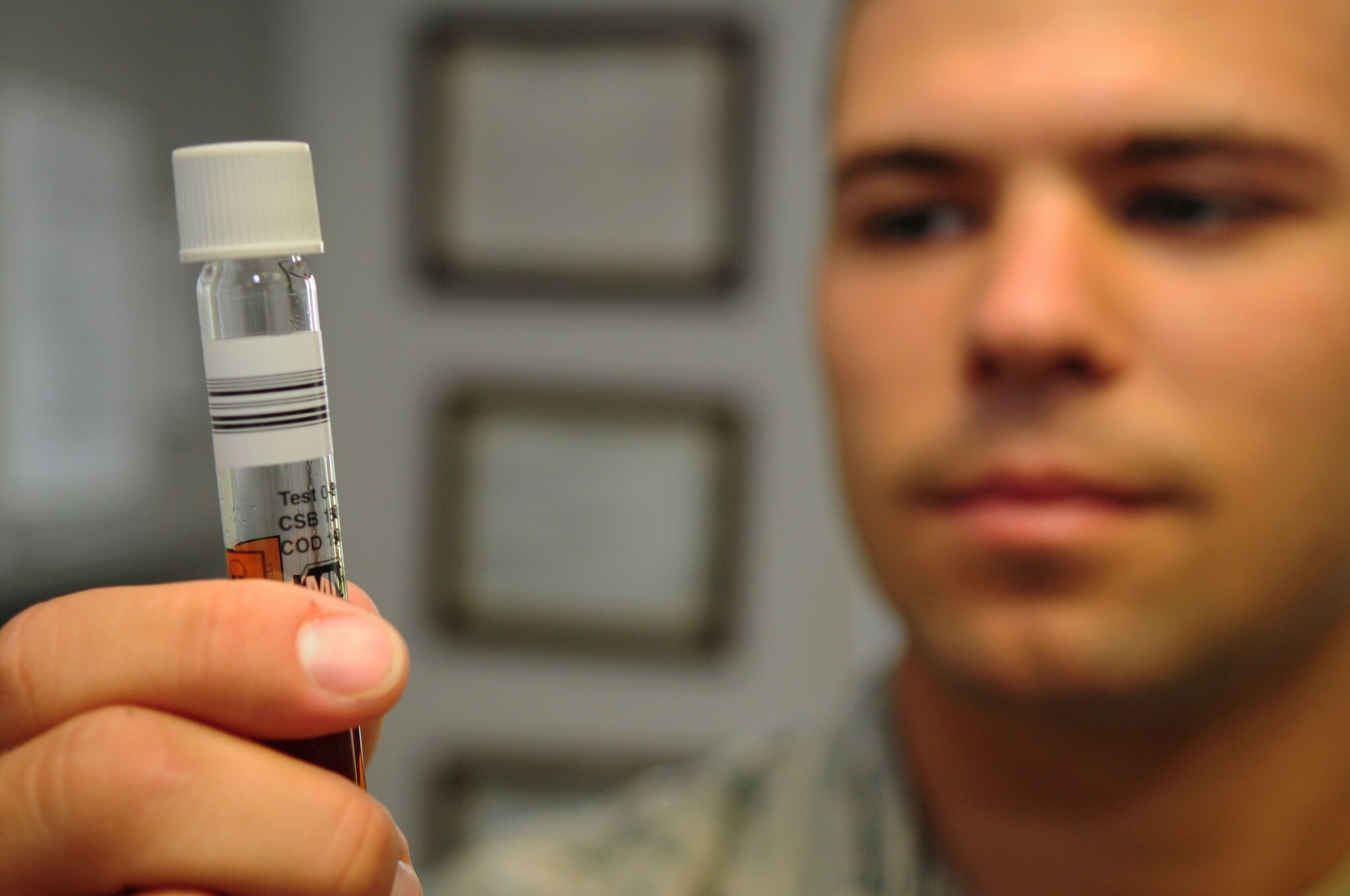 SPANGDAHLEM AIR BASE, Germany – Airman 1st Class Andrew Herget, 52nd Civil Engineer Squadron water and fuel systems maintenance apprentice, holds a water sample to be tested here June 6. The water treatment facility processes wastewater from the base to remove hazardous chemicals before it is released back into the environment. (U.S. Air Force photo/Airman 1st Class Matthew B. Fredericks)