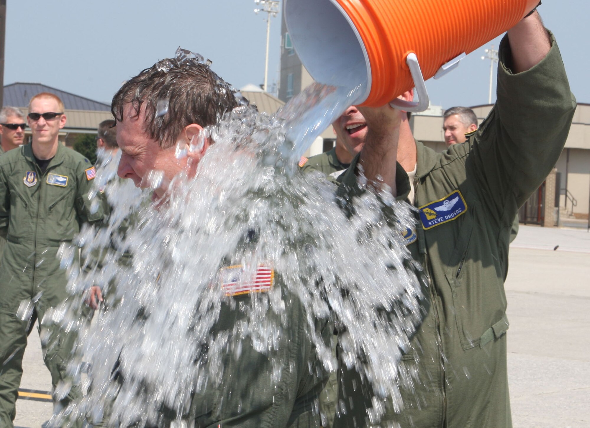 Lt. Col. James M. Dodd receives water bucket soaking from Lt. Col. Steven J. Drosos, Chief Pilot from the 700th Airlift Squadron after completing his final flight prior to his retirement here Jun 4. (U.S. Air Force Photo/Don Peek)