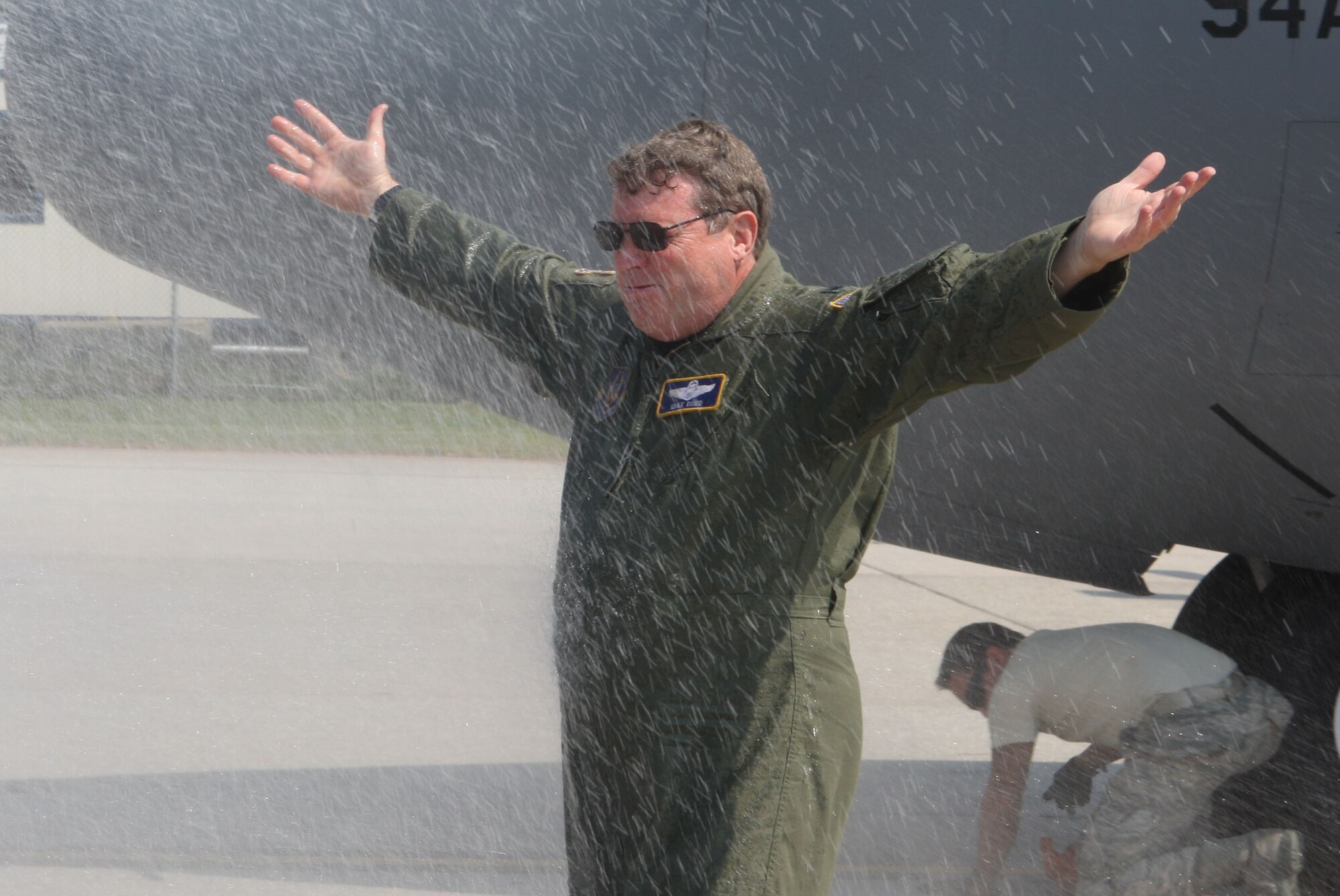Lt. Col. James M. Dodd receives a hose down from his family after his final flight prior to his retirement here on June 4. (U.S. Air Force Photo/Don Peek)