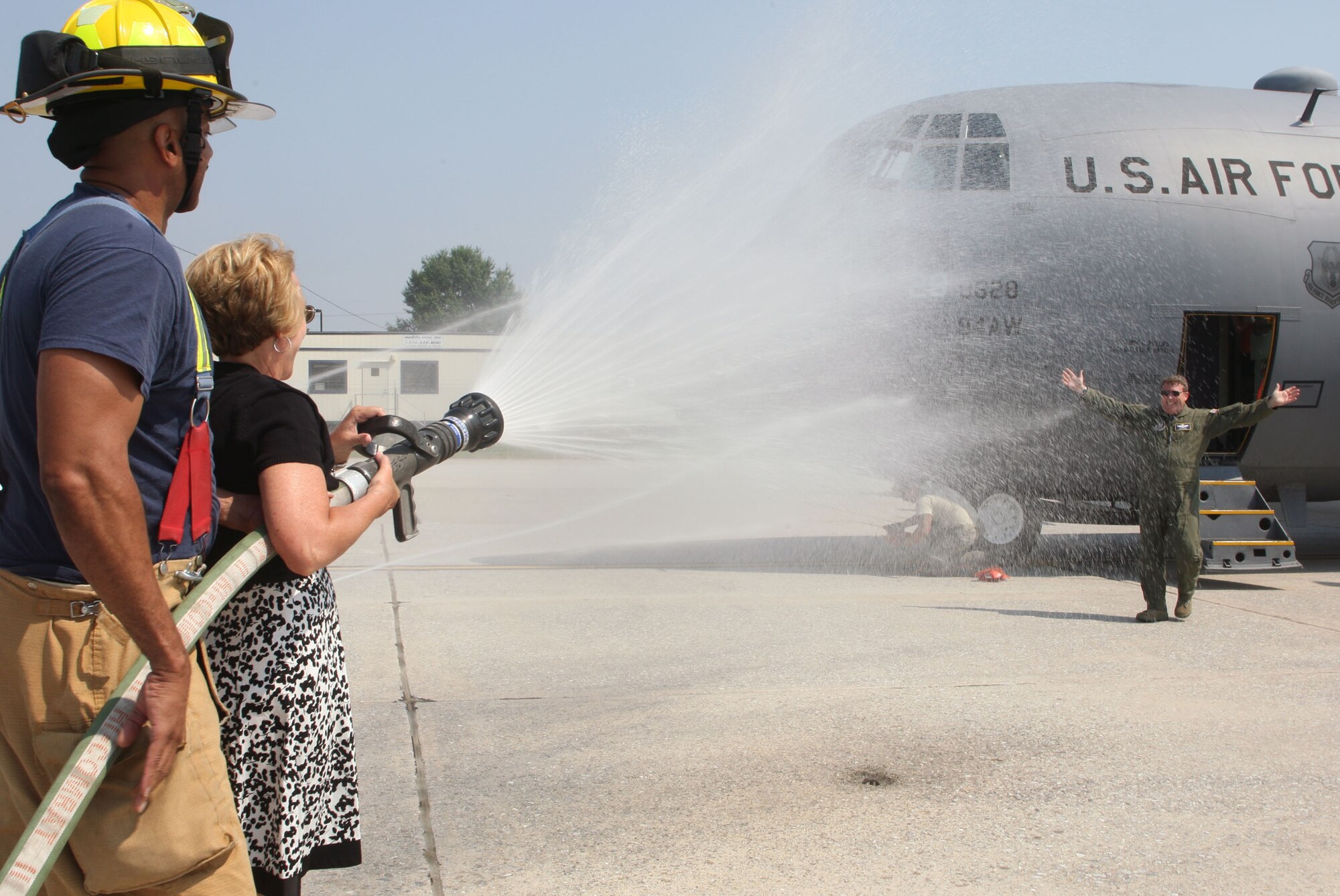 Lt. Col. James M. Dodd receives a hose down from his family after his final flight prior to his retirement here on June 4. (U.S. Air Force Photo/Don Peek)