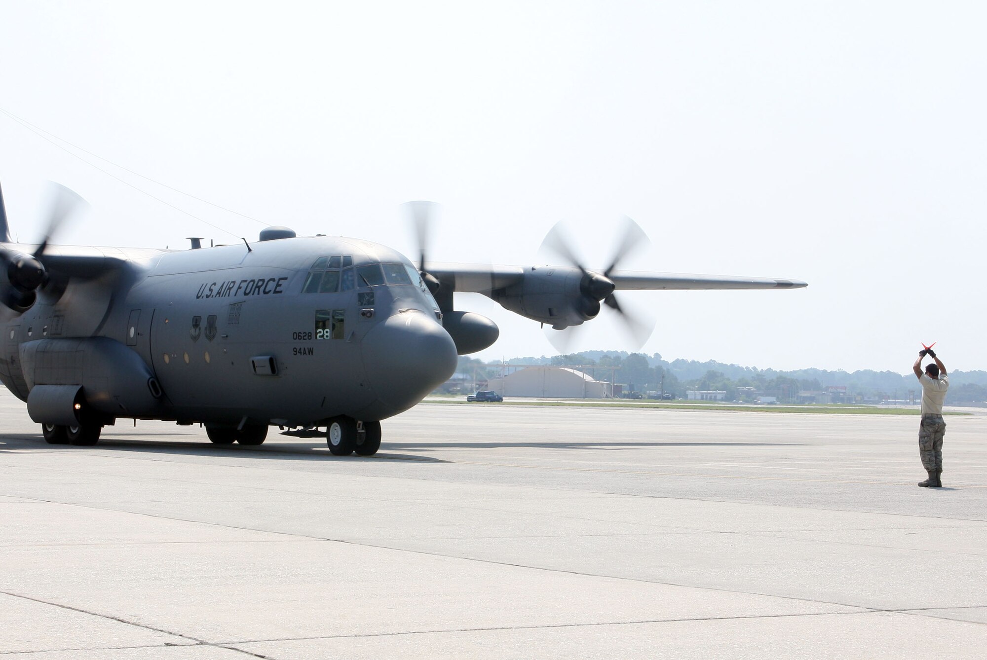 Lt. Col. James M. Dodds C130 is marshaled in as he completes his final flight prior to his retirement June 4. (U.S. Air Force Photo/Don Peek)