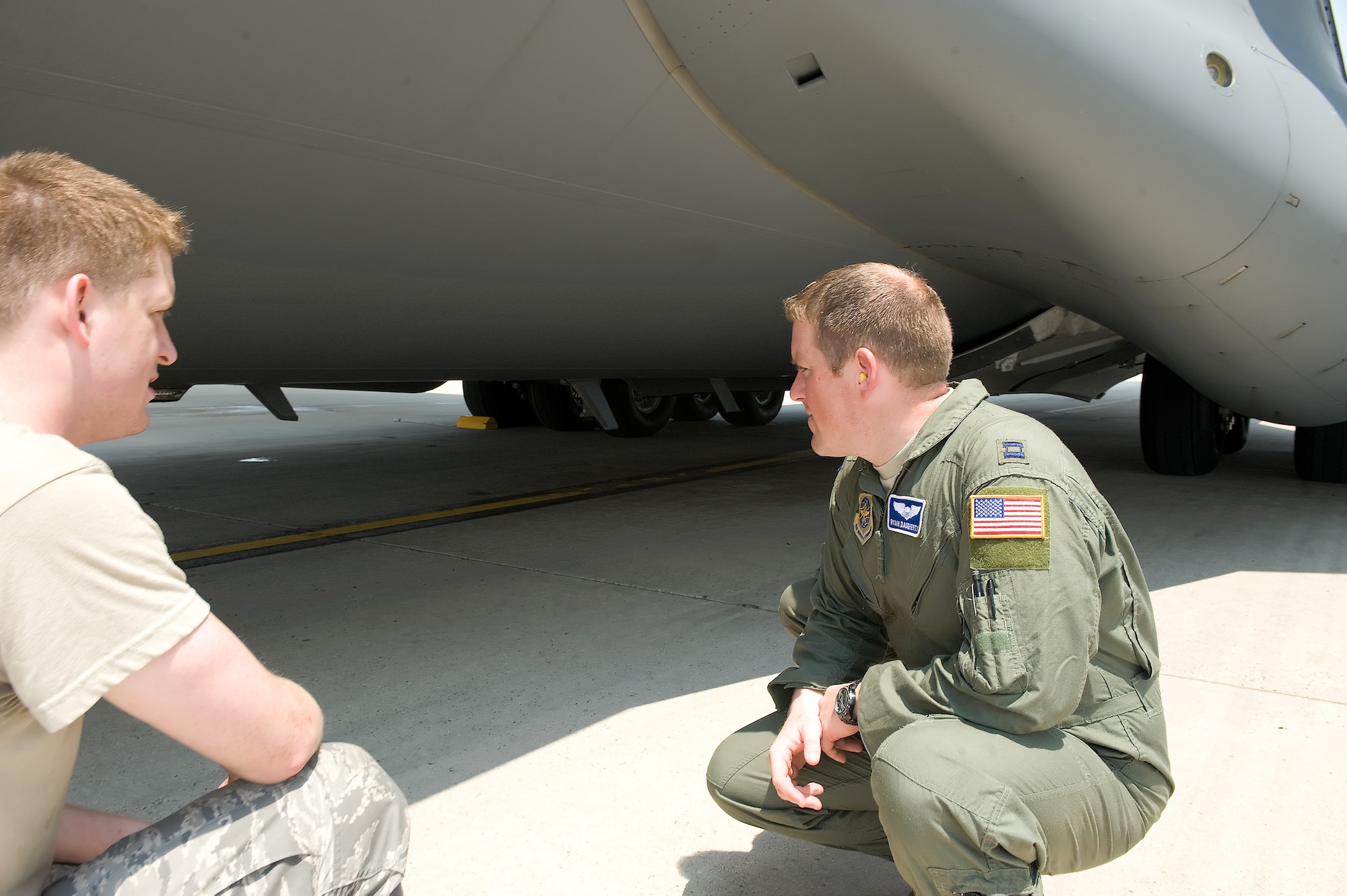 Captain Ryan Daugherty (right), 436th Airlift Wing flight safety officer, talks with Airman 1st Class Josh Shannon, 736th Aircraft Maintenance Squadron, about safety on the C-17 Globemaster III June 1 , 2011, at Dover Air Force Base, Del. (U.S. Air Force photo by Steve Kotecki)