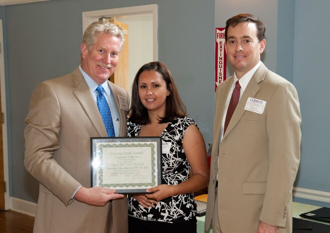 Steve Connor, chairman of the Charleston Pride Committee, left, presents the Captain Pride Award to Cindy McDonald of SSC Atlantic’s Safety and Environmental Engineering Branch and SSC Atlantic Executive Director Christopher Miller during a luncheon May 13 at the Park Circle’s Felix C Davis Community Center in North Charleston.
