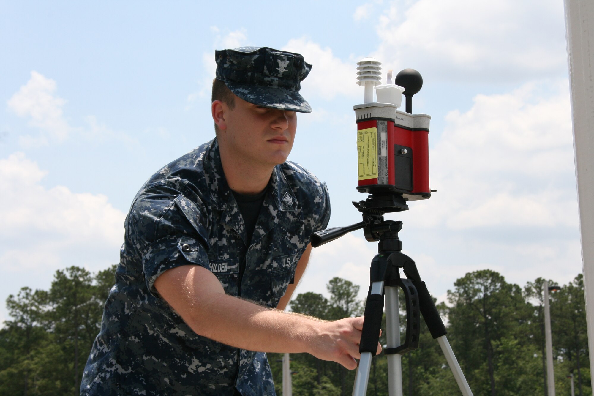 Hospital Corpsman Third Class Kyle Hilden checks the Wet Bulb Globe Temperature at Naval Health Clinic Charleston hourly during the summer months to ensure the most accurate and current heat stress conditions are relayed to base personnel. HM3 Hilden is a Preventive Medicine Technician assigned to Naval Health Clinic Charleston. (U.S. Navy photo/Jeff Kelly)