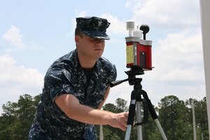 Hospital Corpsman Third Class Kyle Hilden checks the Wet Bulb Globe Temperature at Naval Health Clinic Charleston hourly during the summer months to ensure the most accurate and current heat stress conditions are relayed to base personnel. HM3 Hilden is a Preventive Medicine Technician assigned to Naval Health Clinic Charleston. (U.S. Navy photo/Jeff Kelly)