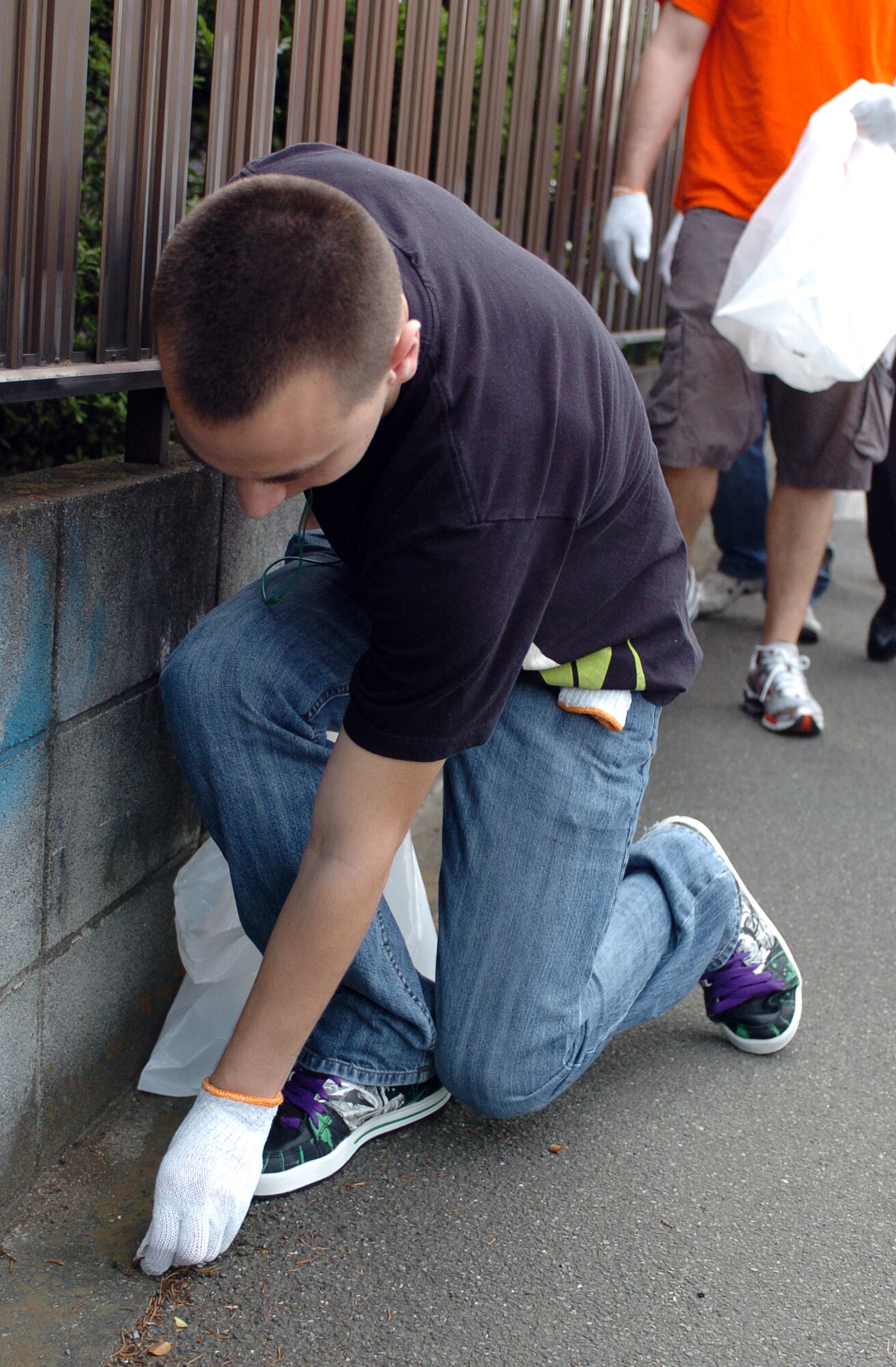 MIZUHO TOWN, Japan -- Airman 1st Class Nolan Locken, a maintainer with the 374th Maintenance Group, collects litter during the 29th annual Mizuho town clean up day outside Yokota Air Base, Japan, June 5, 2011. The annual event is about more than just picking up trash, it is about being good friends and neighbors to the people of Mizuho. (U.S. Air Force photo/Captain Raymond Geoffroy)