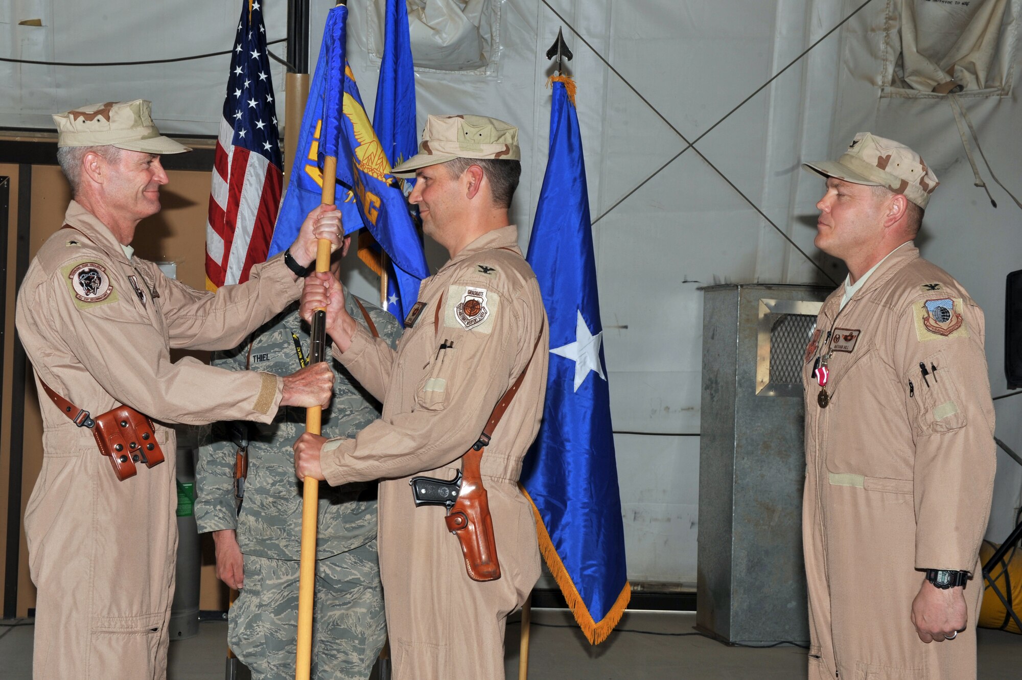 Brig. Gen. Darryl Roberson, 455th Air Expeditionary Wing commander, passes the guidon to Col. Clay Hall during the 455th Expeditionary Operations Group change of command, June 4, 2011, Bagram Airfield, Afghanistan. (U.S. Air Force photo by Senior Airman Sheila deVera)