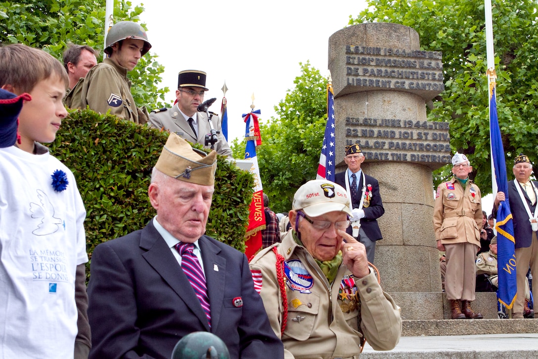 World War II veteran U.S. Army paratrooper and medic Robert Wright reacts with emotion before receiving the French Legion of Honor medal on the 67th anniversary of D-Day, in Sainte Mere Eglise, France, June 6, 2011. Wright, along with fellow medic Ken Moore, cared for more than 70 injured Allied and German troops in the Angoville Church before the town was finally liberated. Wright served with the U.S. Army 101st Airborne Division.