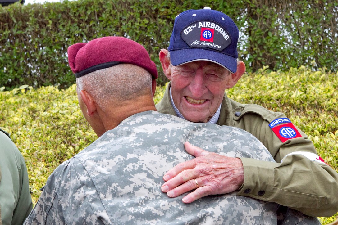 World War II veteran U.S. Army paratrooper and medic Fred Morgan embraces U.S. Army Maj. Gen. Jim Huggins at La Fiere, France, June 5, 2011. Morgan was part of the 82nd Airborne Division that jumped into Normandy during the Allied invasion of France. He and another veteran medic were in La Fiere for the dedication of a memorial plaque to Allied medics. Huggins is the commanding general of the 82nd Airborne Division.