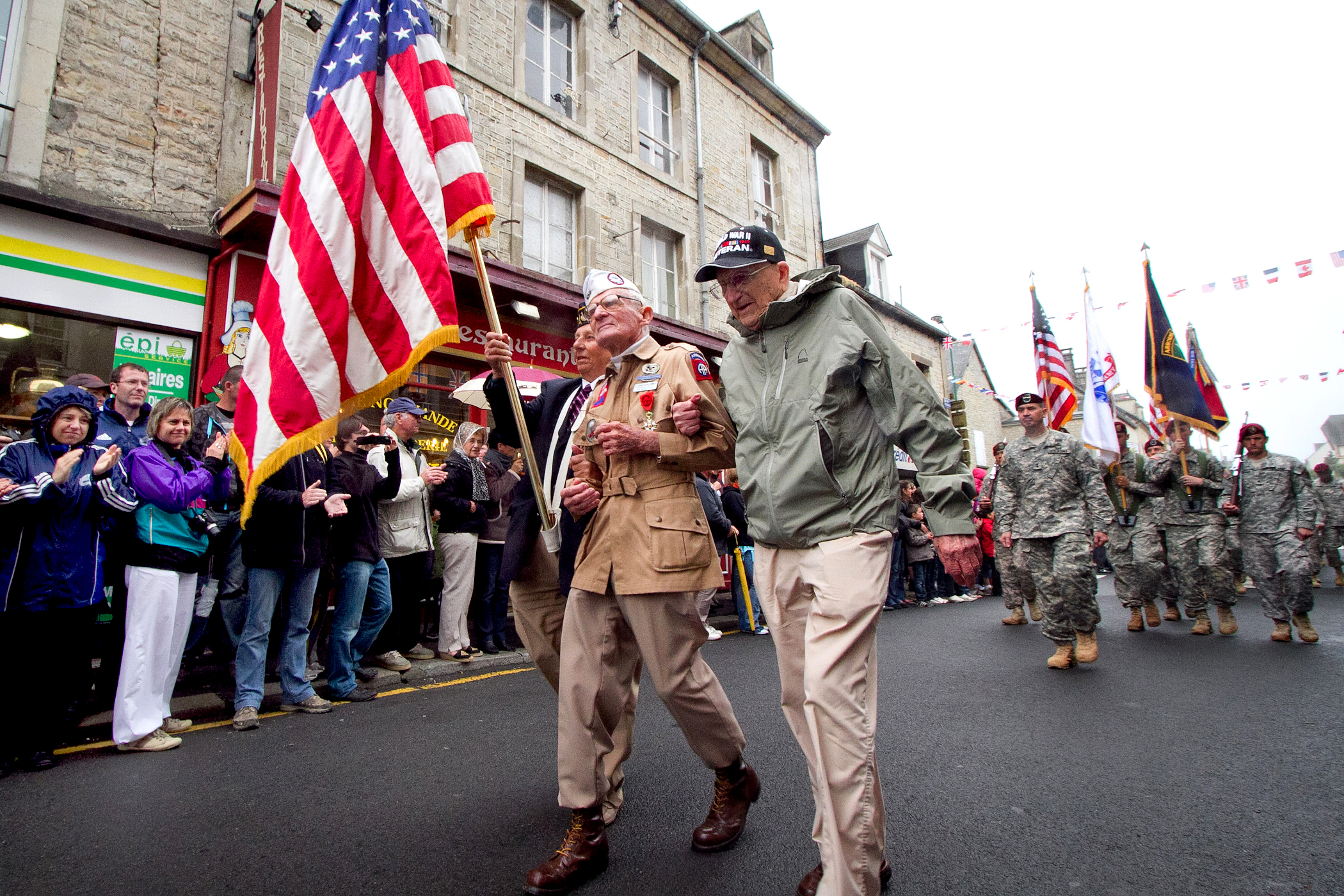 Veteran U.S. Army paratrooper Zane Schlemmer wears his original jump boots as he walks down the