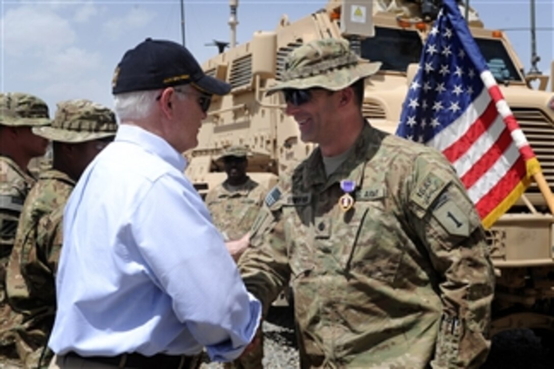 Secretary of Defense Robert M. Gates presents the Purple Heart to Lt. Col. Alan Streeter for wounds received when his combat outpost was attacked at a Forward Operating Base in Afghanistan on June 6, 2011.  