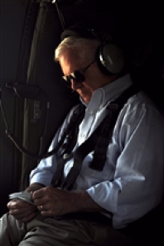 Secretary of Defense Robert M. Gates reviews his notes while flying on a UH-60 Blackhawk helicopter over Afghanistan on June 6, 2011.  
