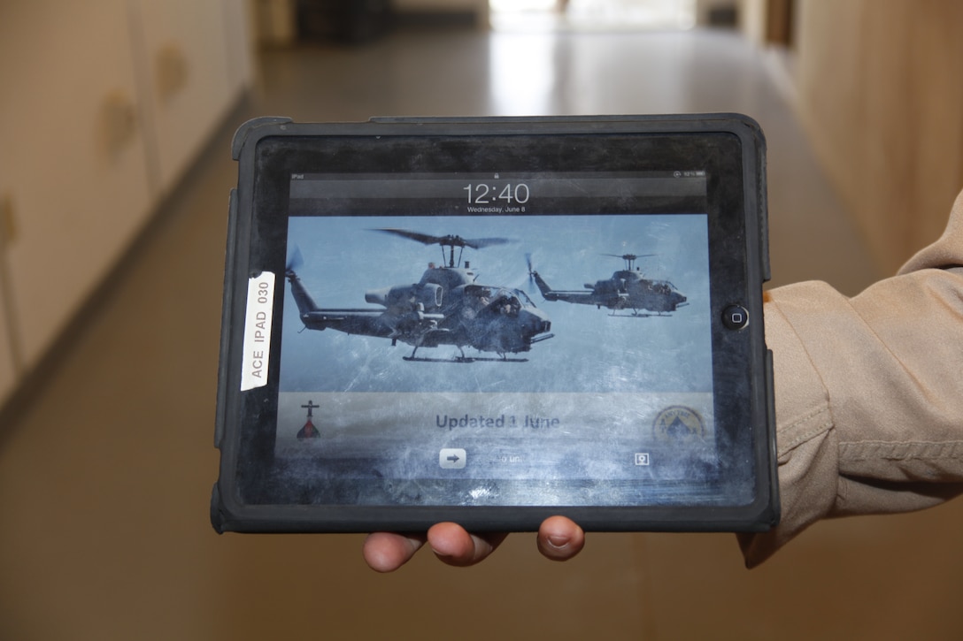 Capt Michael Christman displays an Apple iPad used by AH-1W Super Cobra pilots to quickly access maps and other data they can use to ensure precision strikes are targeted at enemy positions. One advantage of using the tablet over traditional maps is the pilots’ ability to mold its functions to whichever platform they are flying. Christman is an AH-1W Super Cobra pilot with Marine Light Helicopter Squadron 267, based out of Marine Corps Base Camp Pendleton, Calif.