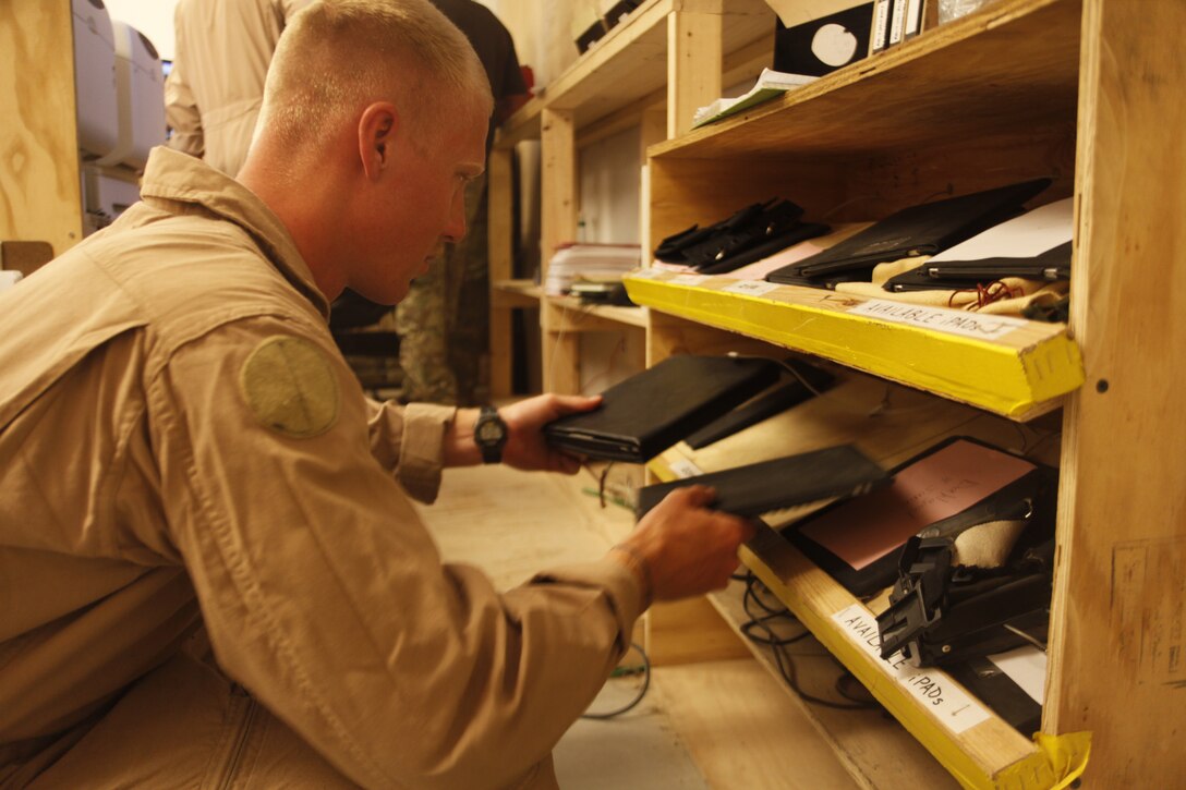 Cpl. Eric Monroe, an UH-1Y Huey crew chief with Marine Light Helicopter Squadron 267, searches for a fully charged iPad  before departing for a mission at Camp Bastion, Afghanistan, June 8. Currently, a handful of 2nd Marine Aircraft Wing (Forward) squadrons use Apple’s iPad in Afghanistan. This includes crewmembers for AH-1W and UH-1Y light attack helicopter squadrons, AV-8B Harrier pilots and the crew of the Harvest Hawk equipped KC-130J.