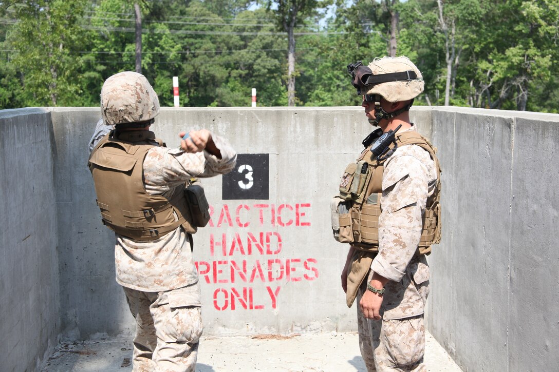Cpl. Richard L. Smith, right, watches as a Marine throws a grenade out of a training pit during Battery B, 2nd Low Altitude Air Defense Battalion’s grenade training at Marine Corps Base Camp Lejeune, June 8. More than 25 Marines conducted the training, throwing two blue body practice grenades for every one live grenade that was thrown. “This training helps my Marines when we deploy to Afghanistan,” said 1st Lt. Konrad N. Reese, platoon commander for 2nd Platoon, Battery B, 2nd LAAD Bn.