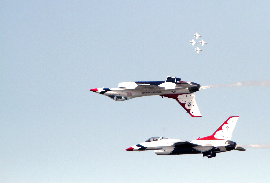 Two F-16s from the U.S. Air Force Aerial Demonstration Squadron, the Thunderbirds, perform a "Calypso pass," which involves Thunderbird 5, lead solo flown by Maj. Aaron Jelinek and Maj. J.R. Williams flying Thunderbird 6, as the opposing solo, for a large crowd at the “Thunder Over the Black Sea” air show held here, June 8, that was attended by local vendors as well as U.S. Marines from Black Sea Rotational Force 11, to display Romanian and U.S. military air power. Marines from Black Sea Rotational Force-11 participated in a “Thunder Over the Black Sea” air show along with U.S. Air Force Demonstration Squadron, the Thunderbirds, and several Romanian aerial demonstration squadrons on June 8 to display Romanian and U.S. air capabilities to the locals in the area.