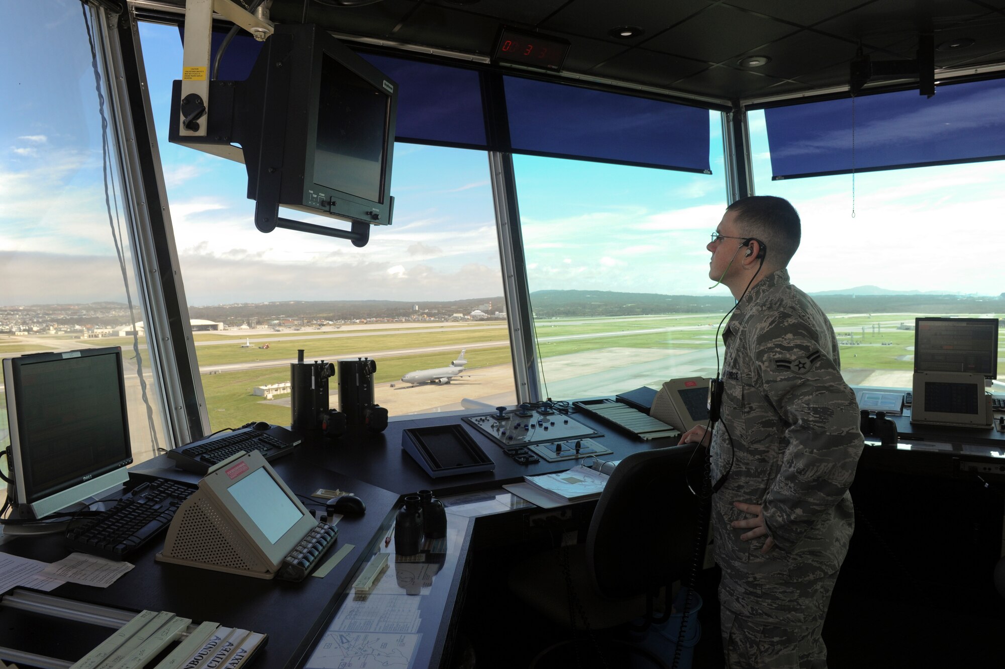 Airman 1st Class Kevin Lietz, 18th Operation Support Squadron air traffic controller, looks over the Kadena flight line while waiting for an aircraft to land, June 7. Air traffic controllers go through extensive training so that they can help flight missions run smoothly and efficiently. (U.S. Air Force photo/ Airman 1st Class Brooke Beers)