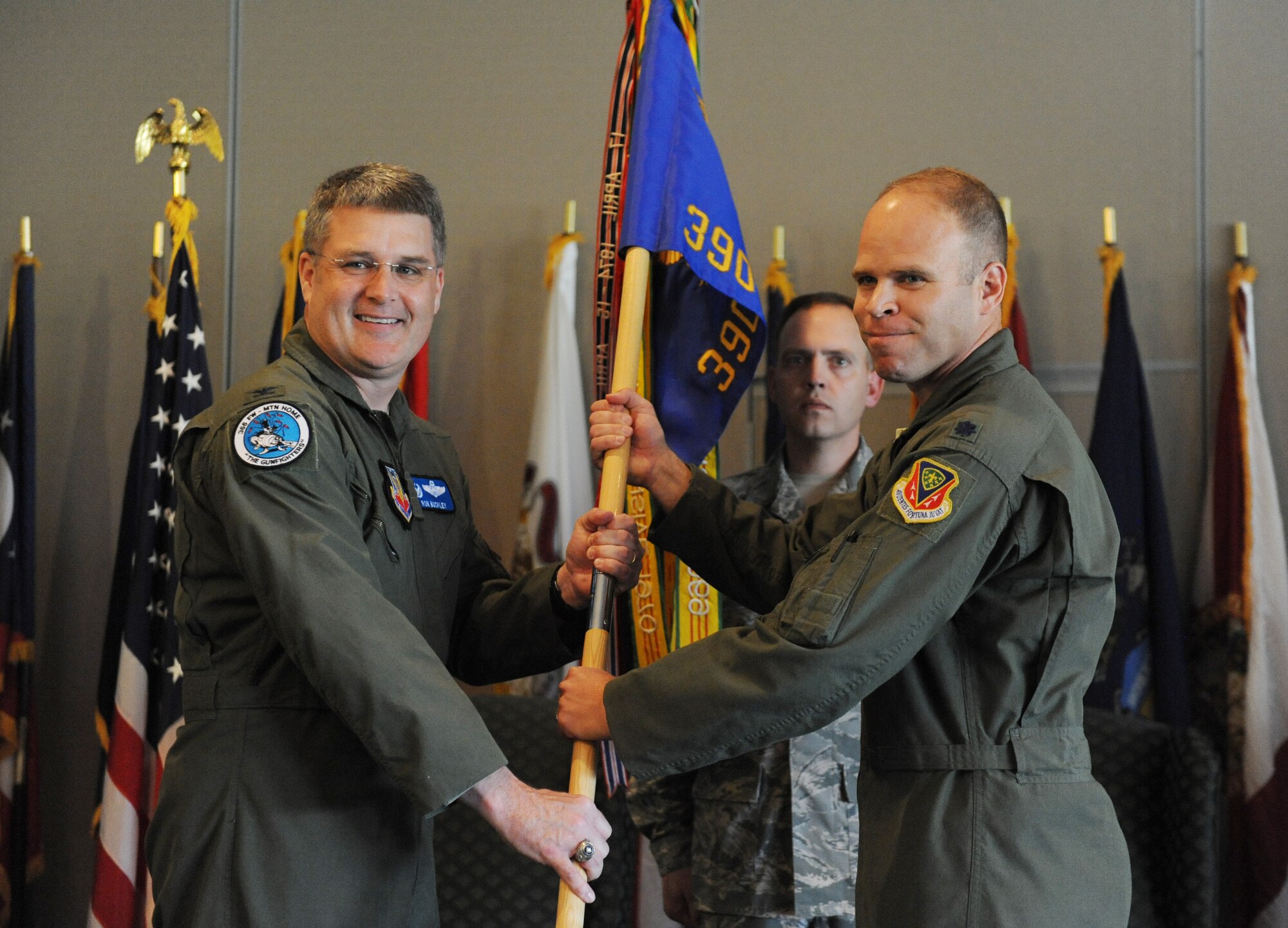 NAVAL AIR STATION WHIDBEY ISLAND, Wash. -- Col. Ron Buckley, left, 366th Fighter Wing commander, passes the guidon to Lt. Col. Karl Fischbach, 390th Electronic Combat Squadron, to signify his assumption of command at the 390th ECS Change of Command Ceremony here June 8. Colonel Fischbach has been at Whidbey since April 2009 as the director of operations. (U.S. Air Force photo by Staff Sgt. Gina Chiaverotti-Paige)