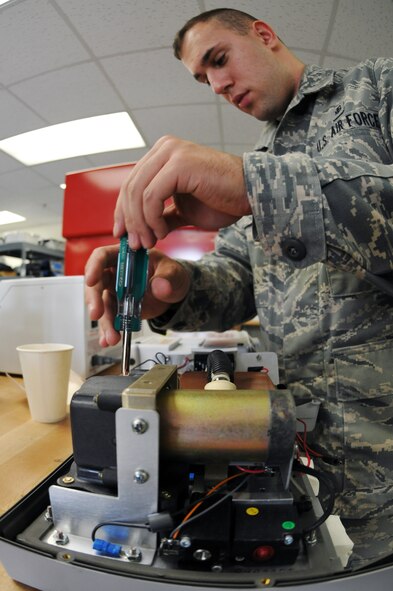 KUNSAN AIR BASE, Republic of Korea -- Senior Airman Luke Laris, 8th Medical Support Squadron bio-medical equipment repair technician, reassembles a surgical suction unit here June 8. Biomedical technicians implement organizational maintenance support for all medical devices used within the medical treatment facility, medical research laboratories, air transportable hospitals and clinics and contingency hospitals. (U.S. Air Force photo/Senior Airman Brittany Y. Bateman)