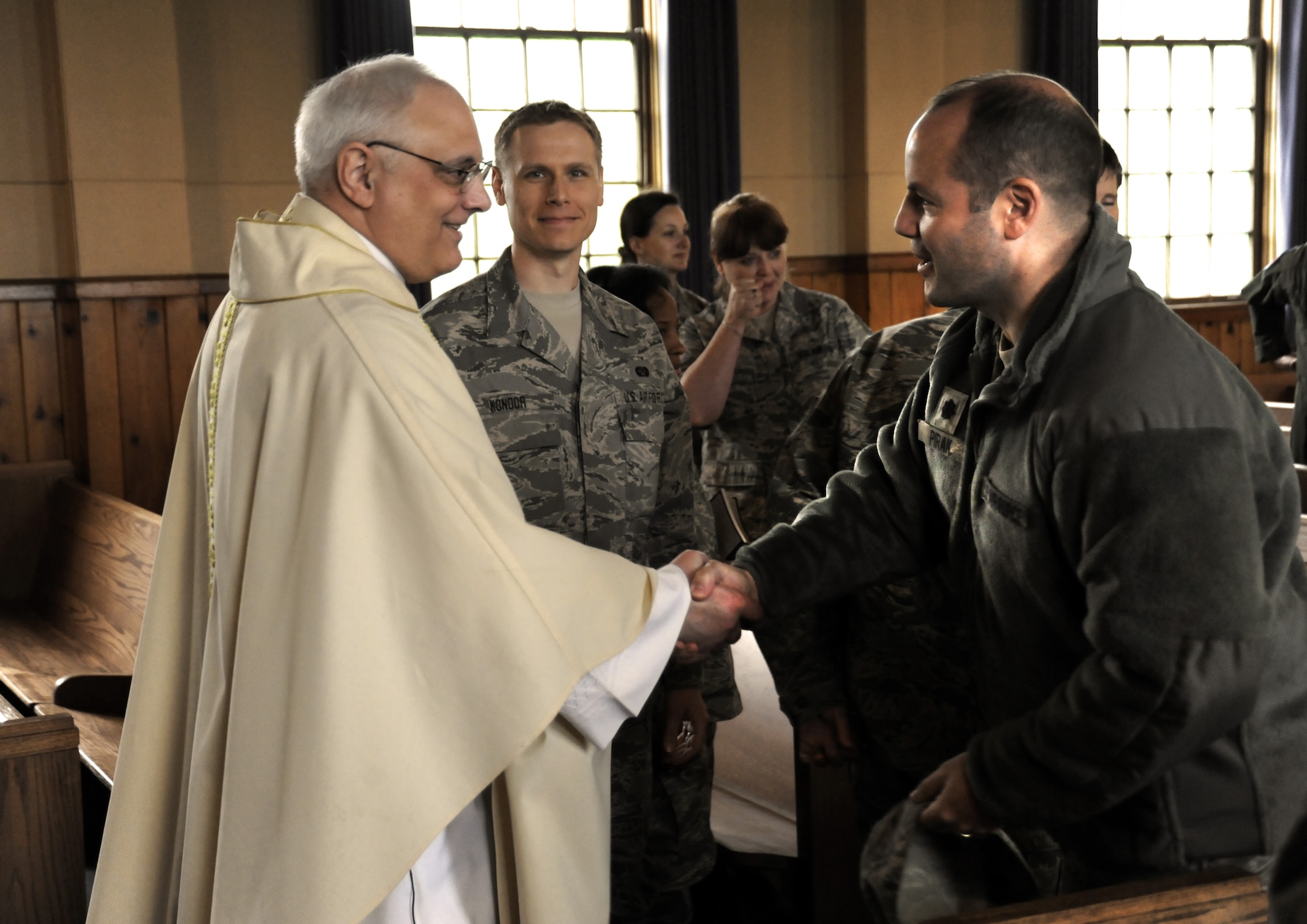 U.S. Air Force Lt. Col. Rick Sirianni greets Lt. Col. Duke Pirak during mass held on May 15, 2011 at the Portland Air National Guard Base, Portland, Ore., during the 142nd Fighter Wing Unit Training Assembly. This was Father Sirianni's last mass before he retires from the Oregon Air National Guard after 23 years of service. (U.S. Air Force photograph by Tech. Sgt. John Hughel) (Released)