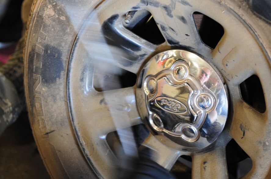 Tech. Sgt. Vincent St. Hilaire, 2nd Logistics Readiness Squadron, NCO-in-charge of allied trades, strikes a hub cap to secure it in place after changing a tire at the vehicle maintenance center located on Barksdale Air Force Base, La., June 8. The vehicle was brought to the shop with a punctured tire. A spare tire was used until a new tire could be ordered and installed. (U.S. Air Force photo/Senior Airman Joanna M. Kresge)