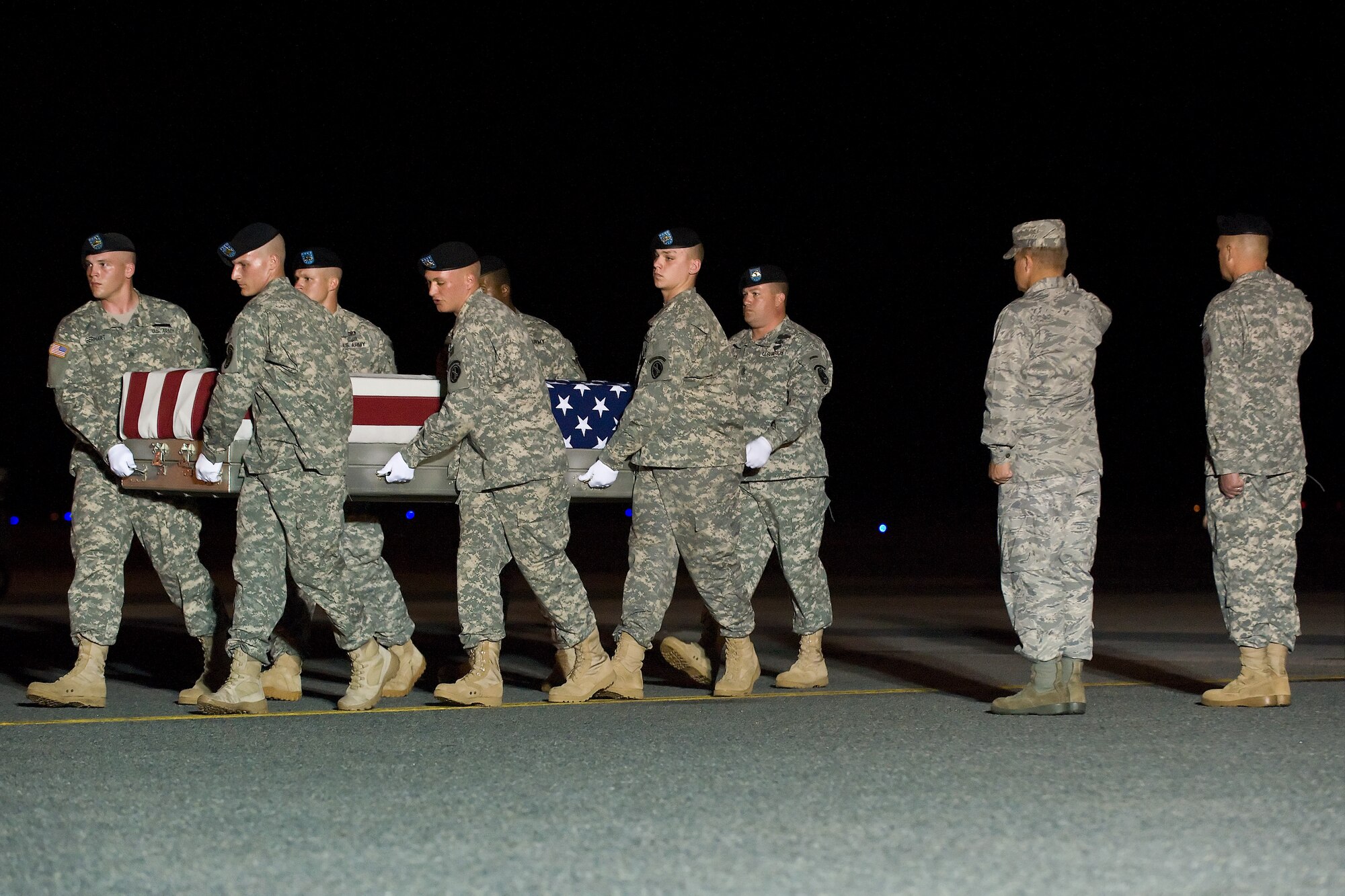 A U.S. Army carry team transfers the remains of Army Pfc. Michael C. Olivieri, of Chicago, Ill., at Dover Air Force Base, Del., June 8, 2011. He was assigned to the1st Battalion, 7th Field Artillery Regiment, 2nd Heavy Brigade Combat Team, 1st Infantry Division, Fort Riley, Kan. (U.S. Air Force photo/Roland Balik)

